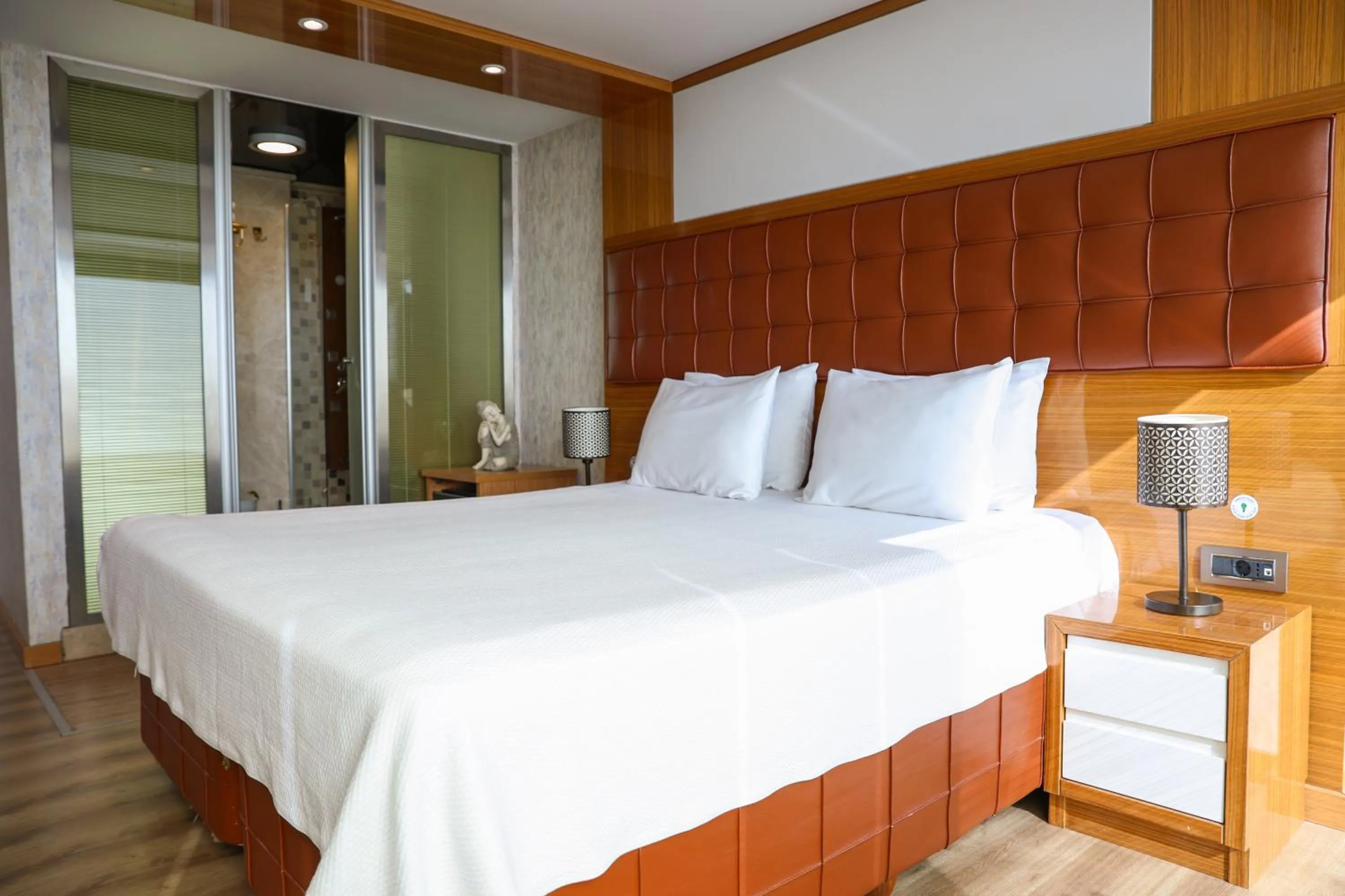 Bed in The Hera Platinum Hotel