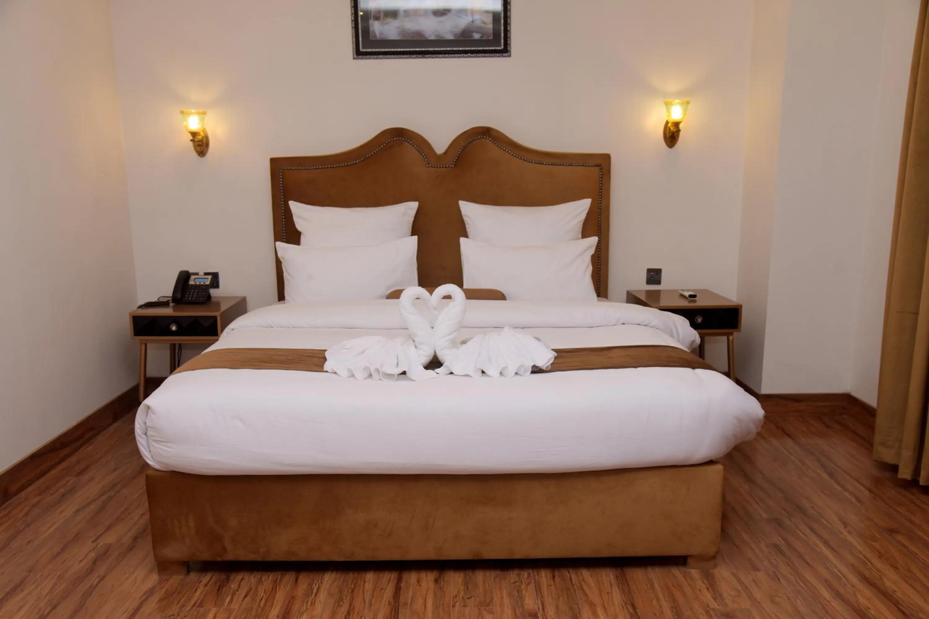 Bed in The Rich Hotel & Apartments