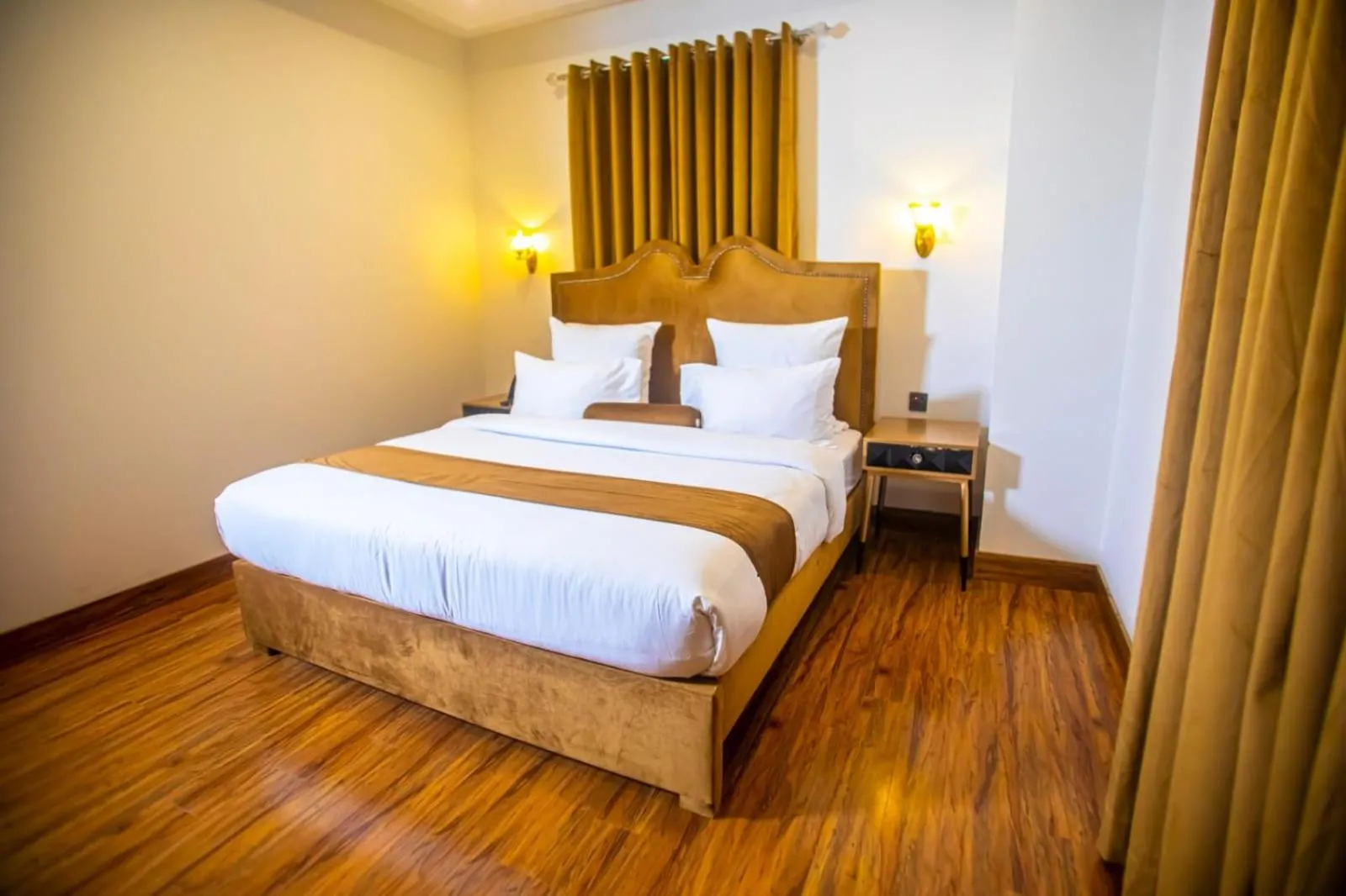 Bed in The Rich Hotel & Apartments