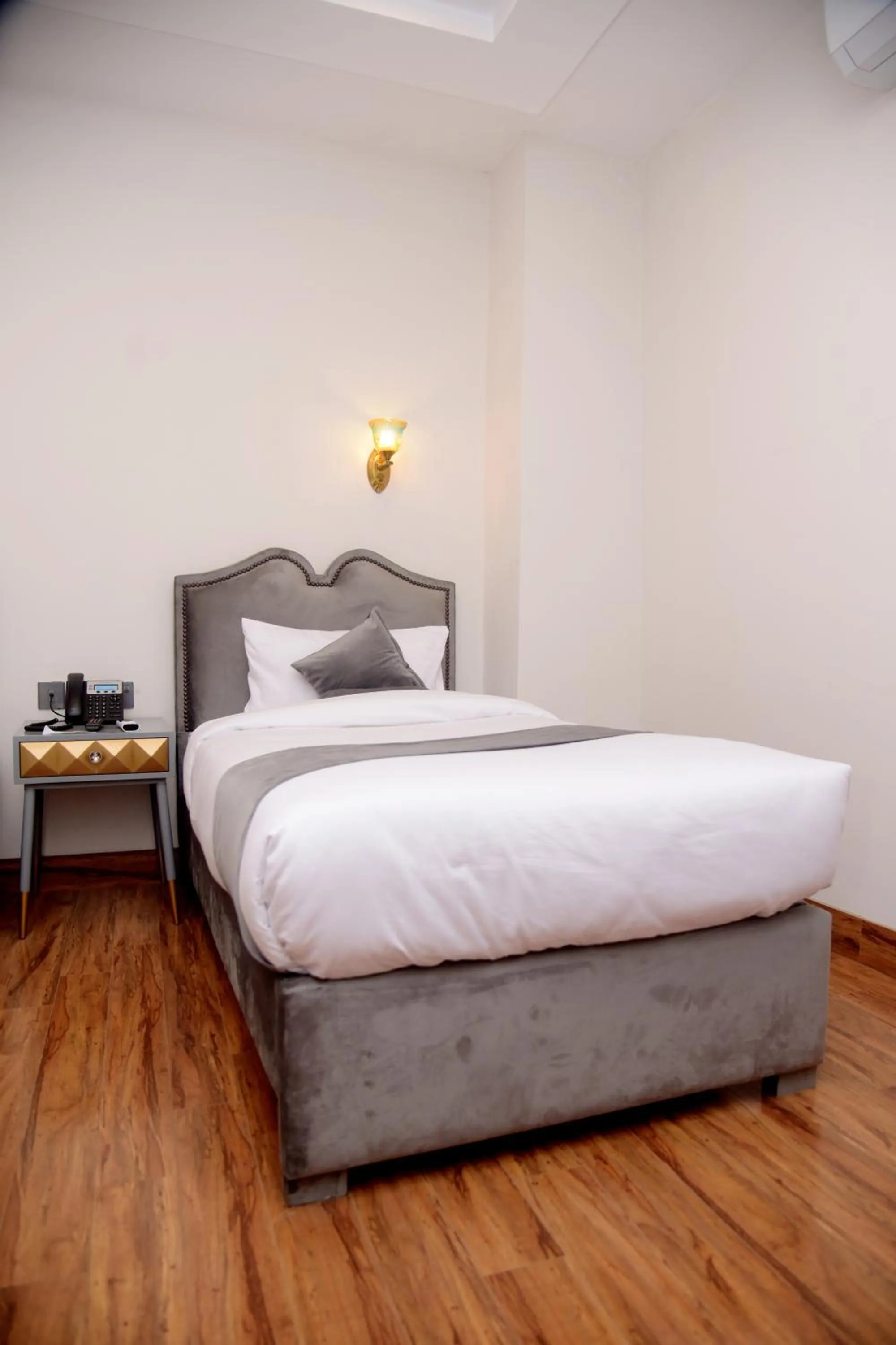 Bed in The Rich Hotel & Apartments