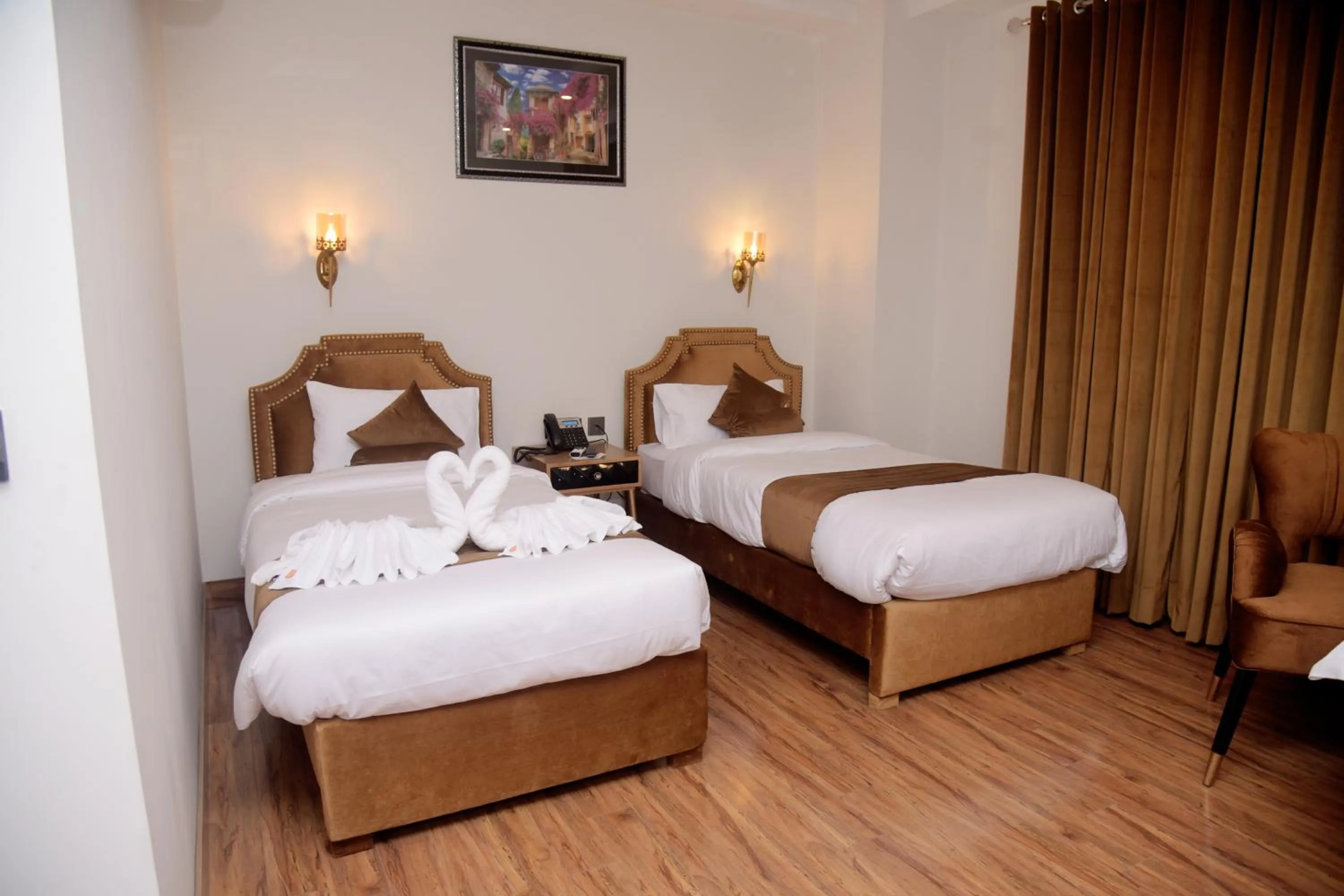 Bed in The Rich Hotel & Apartments