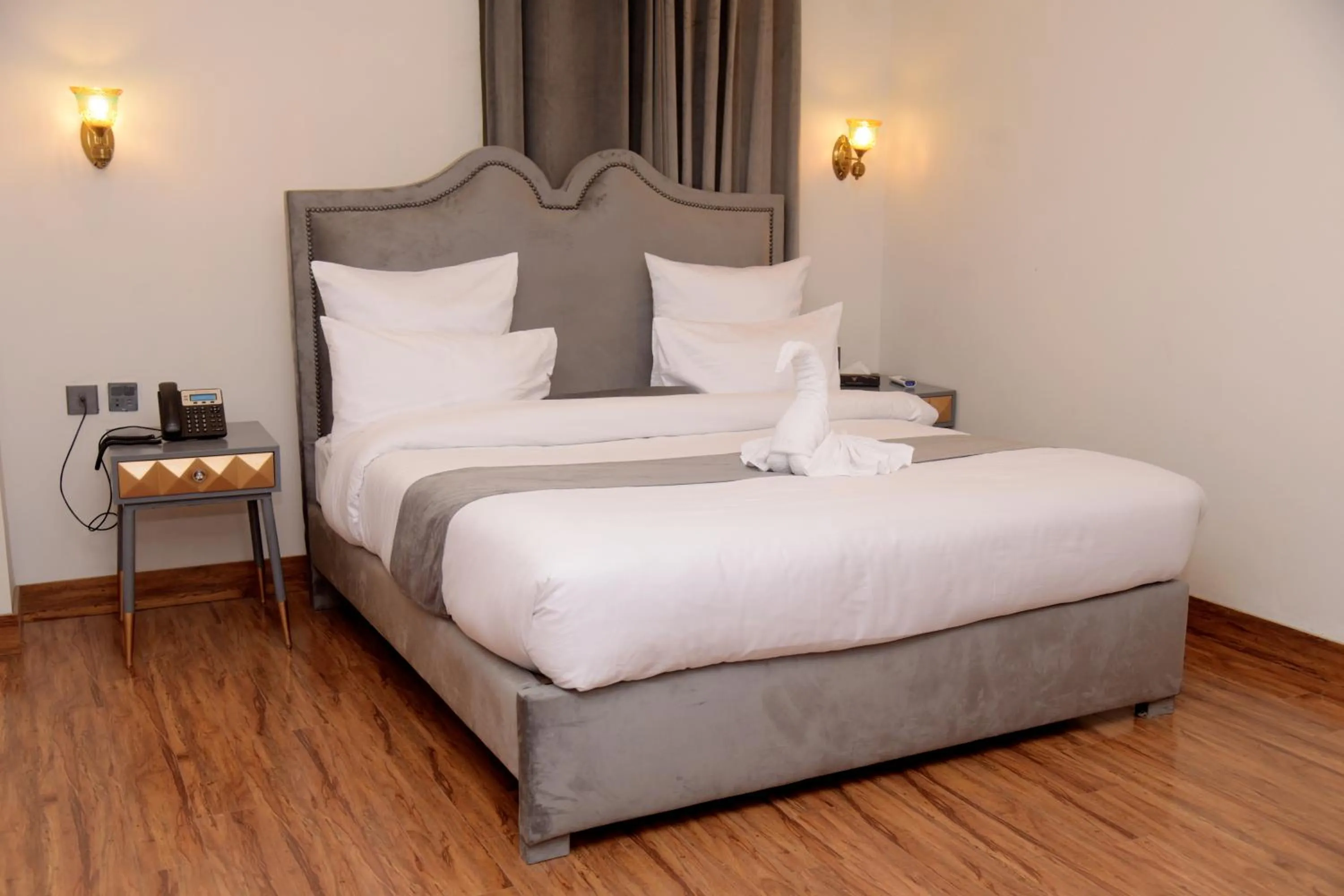 Bed in The Rich Hotel & Apartments