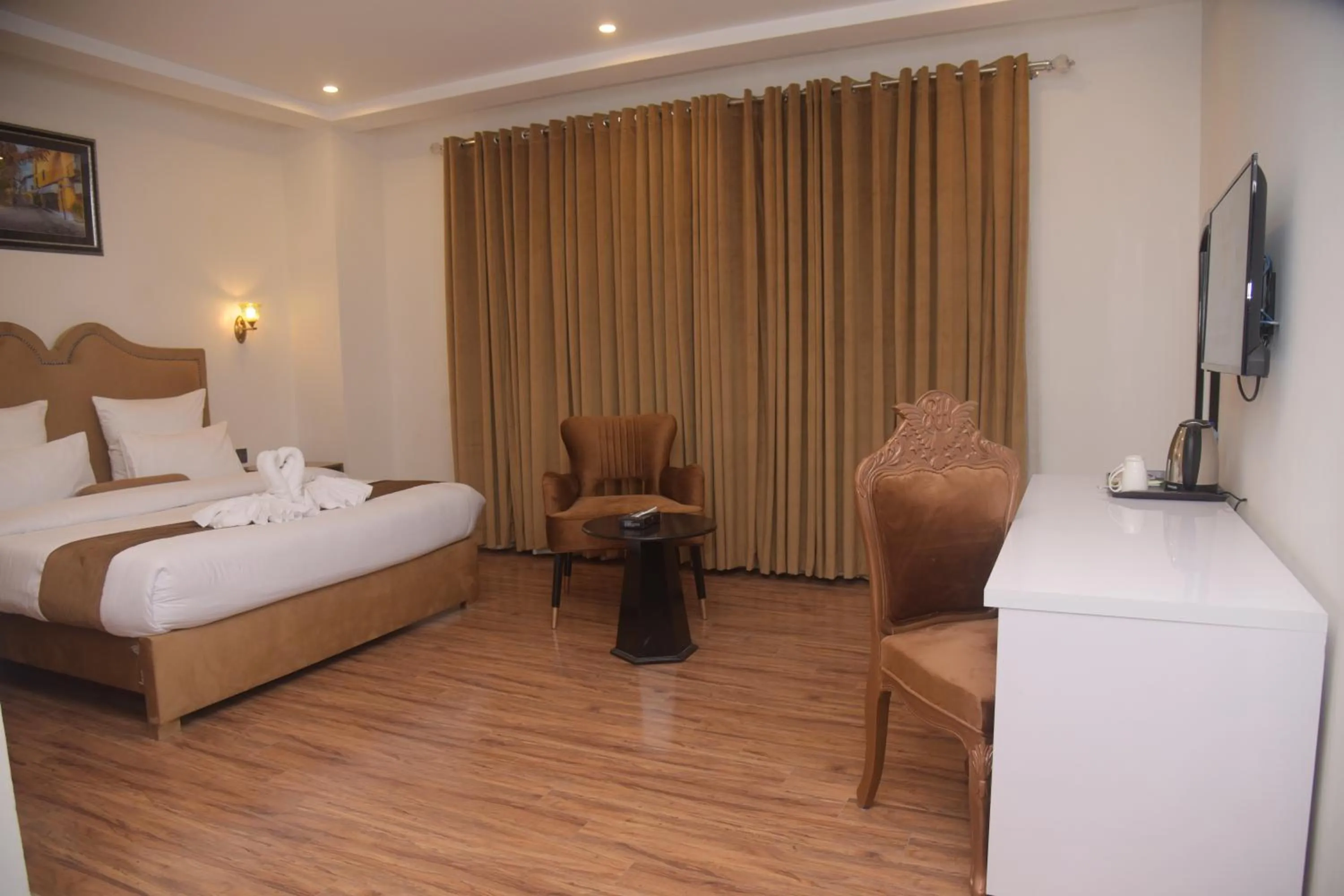 Bed in The Rich Hotel & Apartments