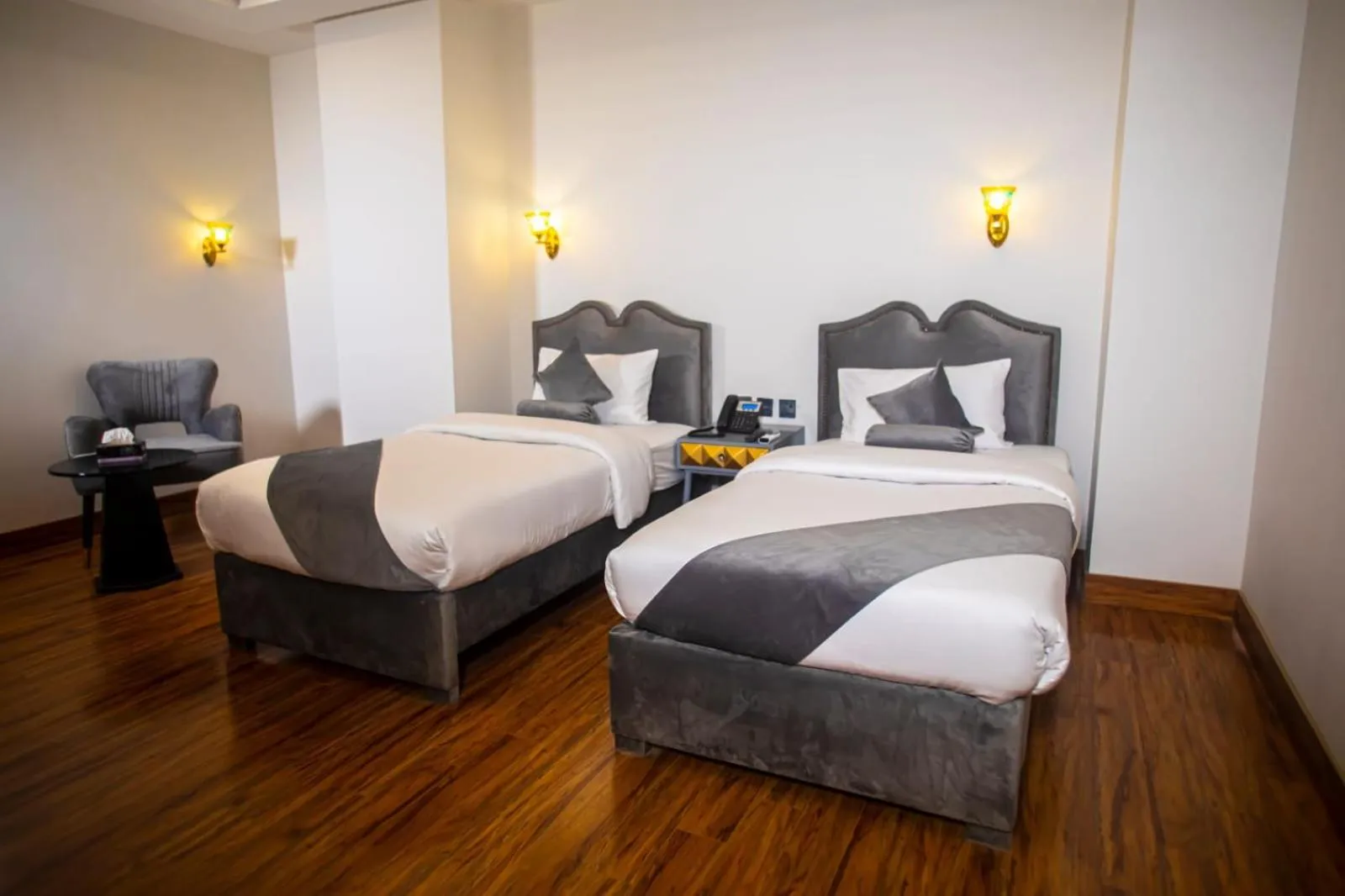 Bed in The Rich Hotel & Apartments