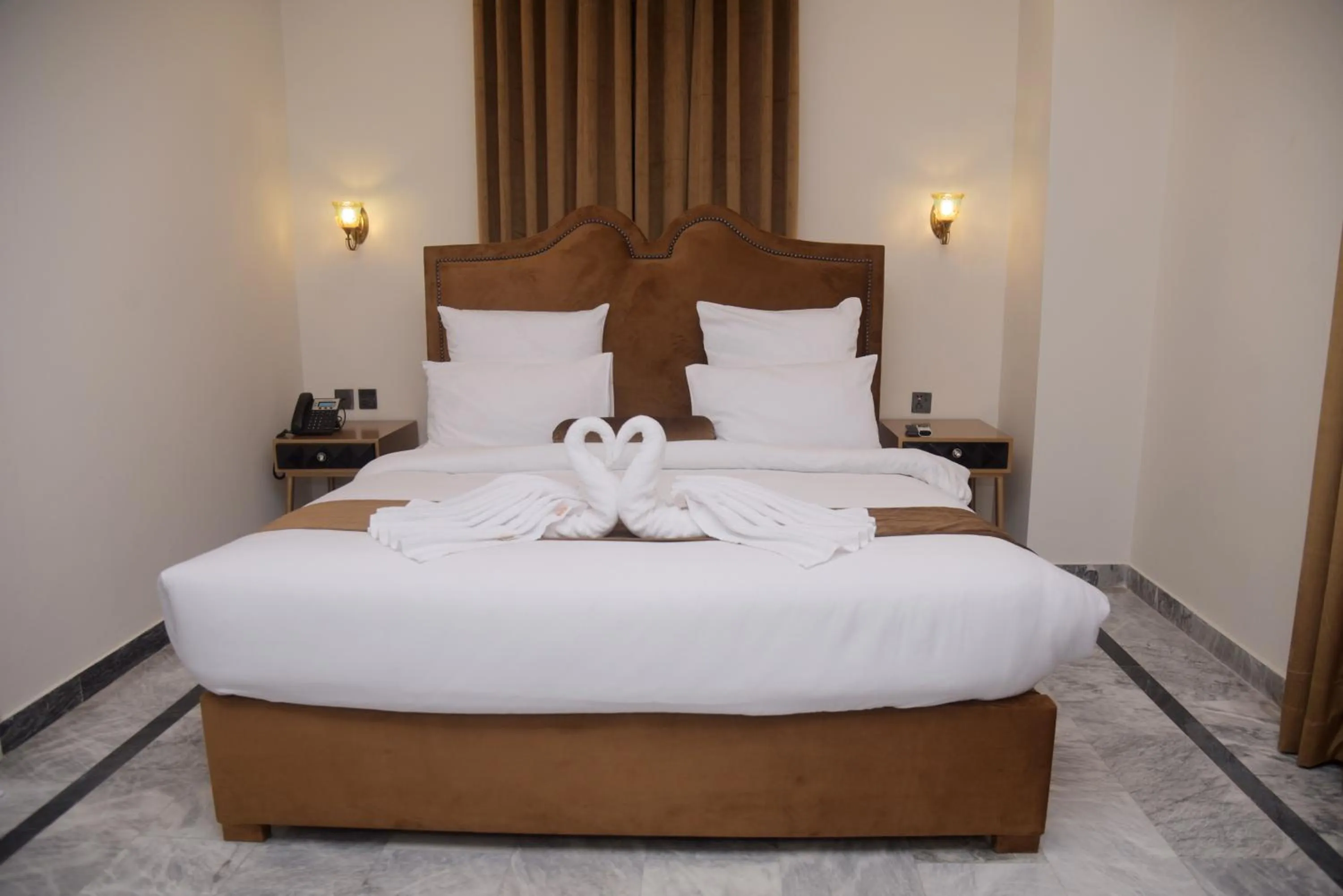 Bed in The Rich Hotel & Apartments