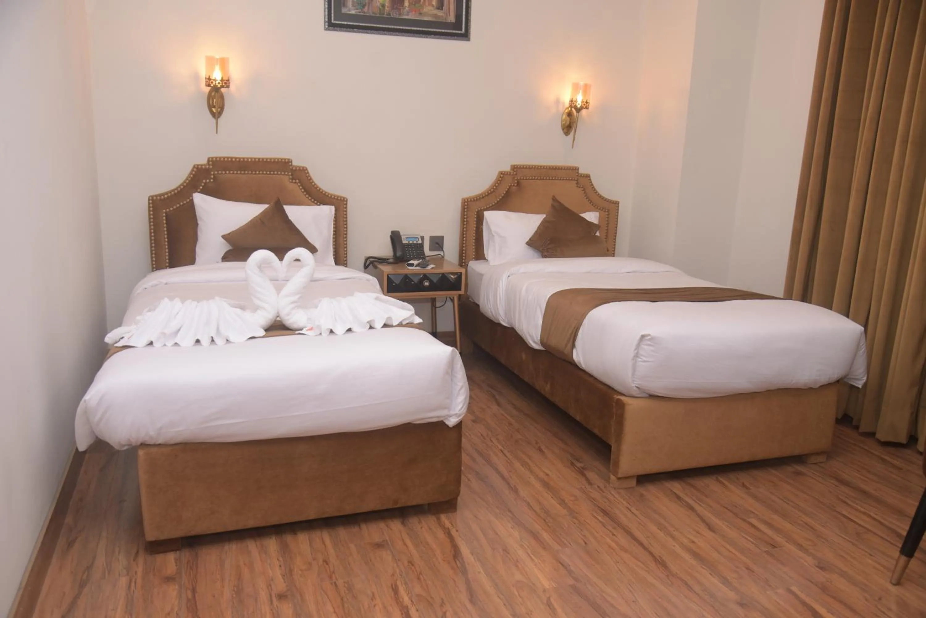 Bed in The Rich Hotel & Apartments