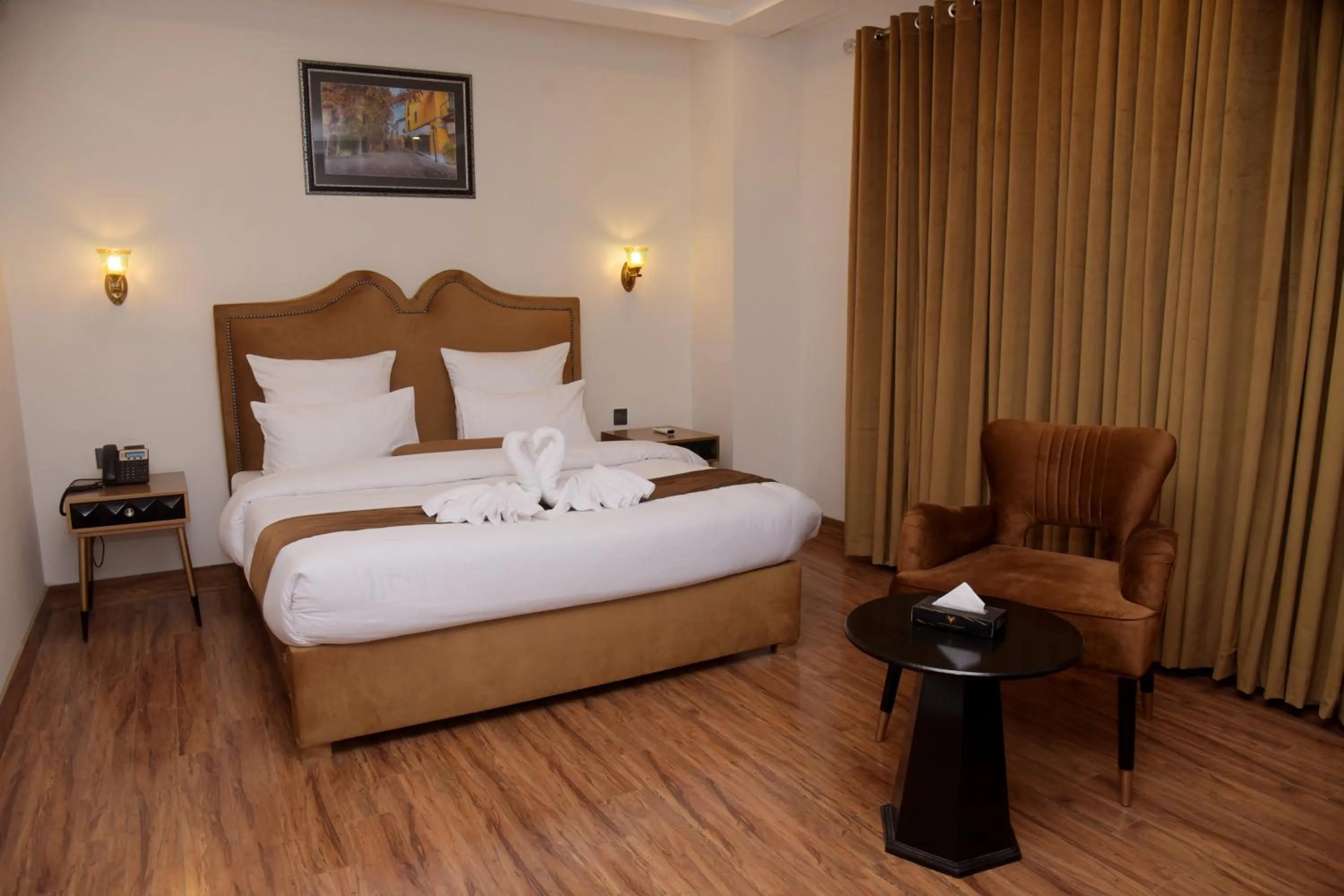 Bed in The Rich Hotel & Apartments