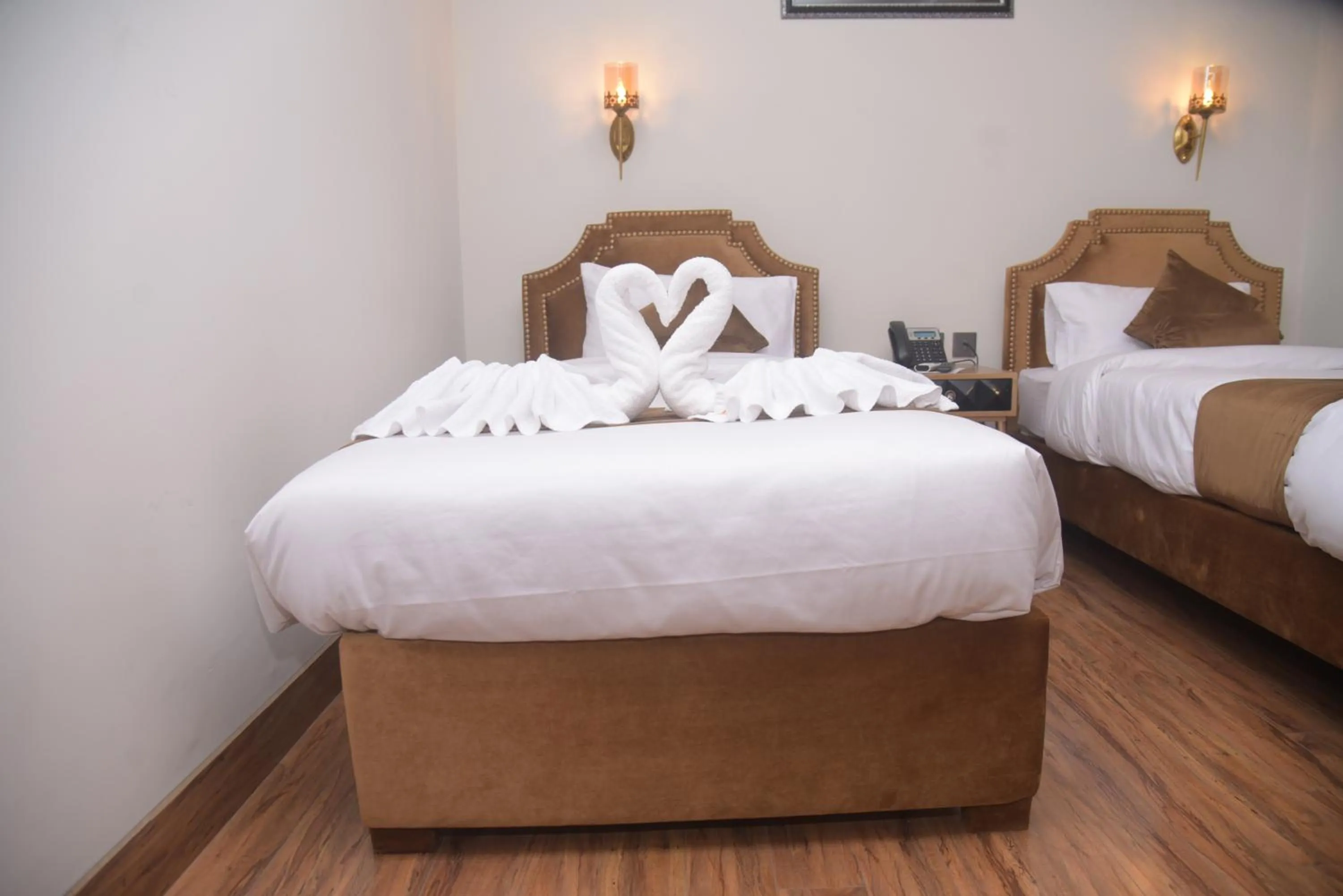 Bed in The Rich Hotel & Apartments