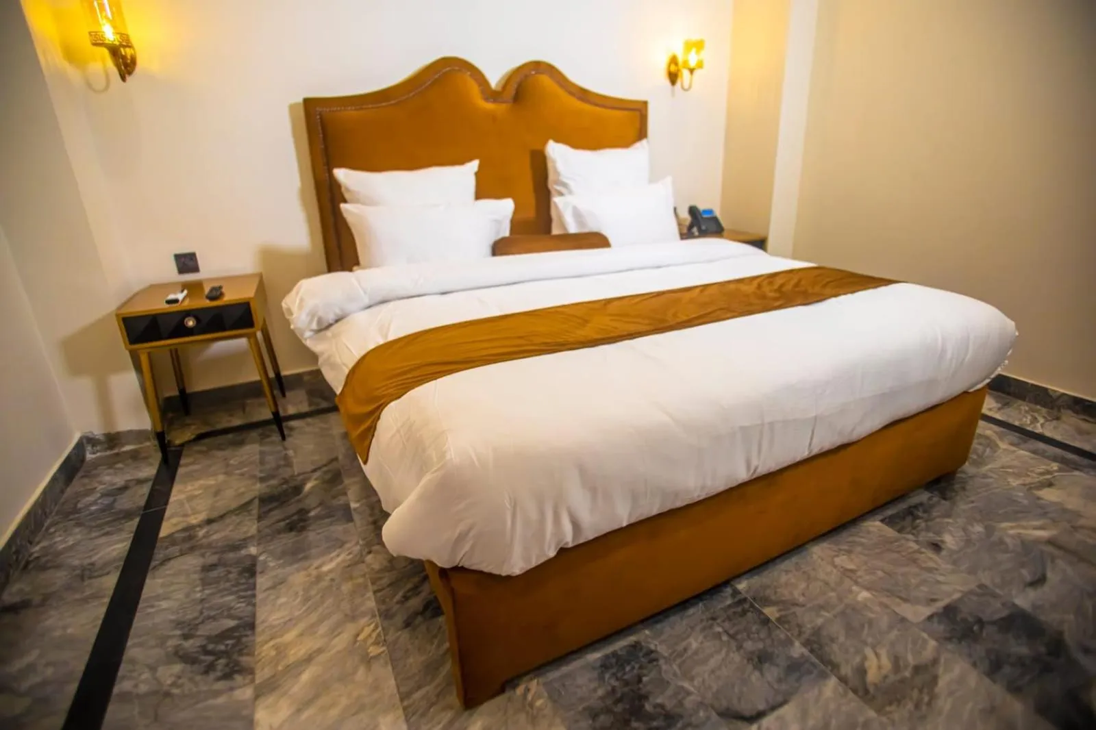 Bed in The Rich Hotel & Apartments