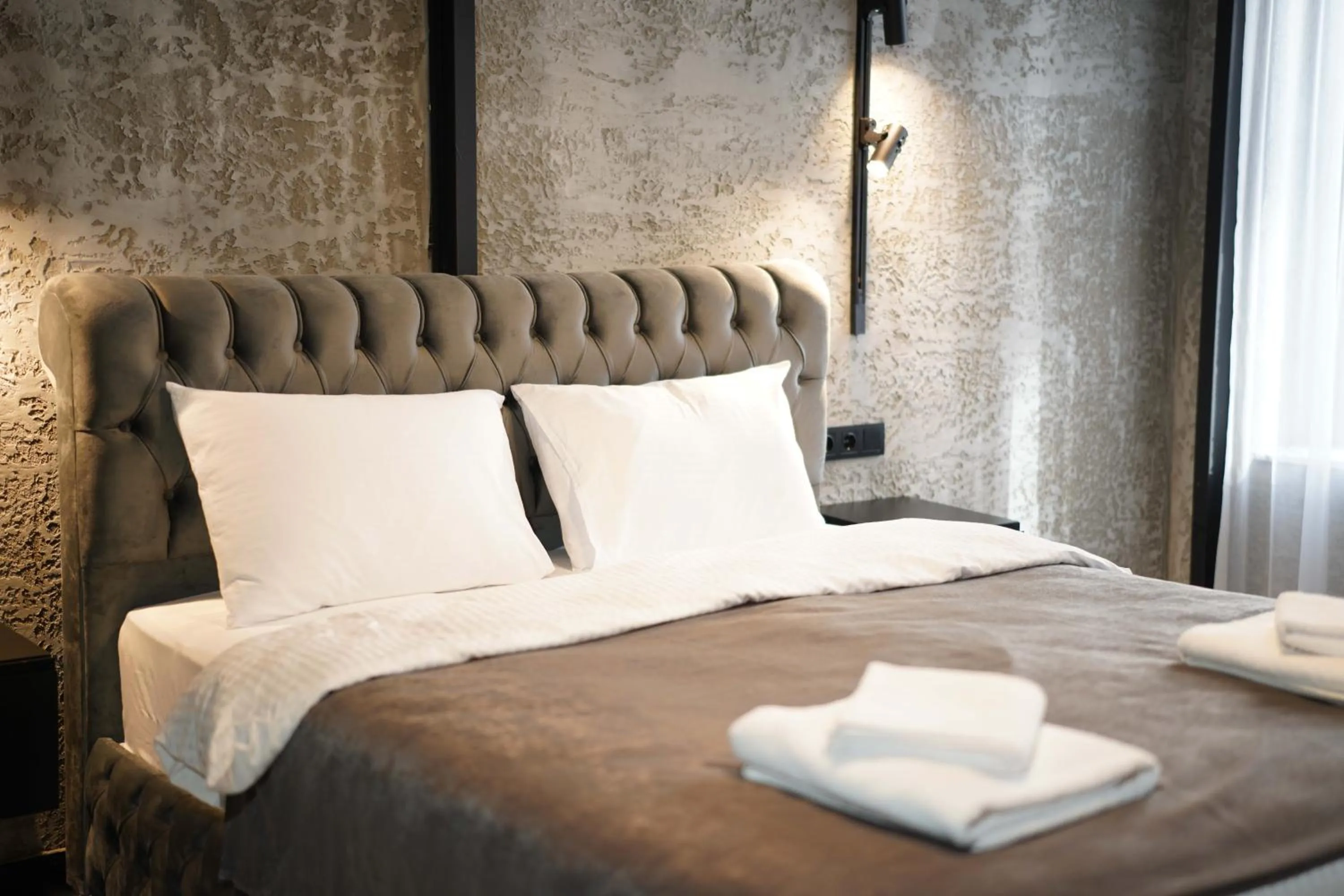 Bed in Monev Suites Hotel