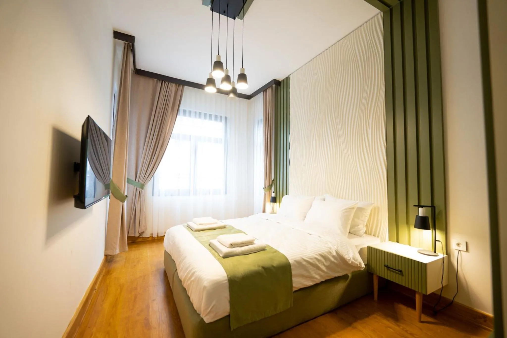 Bed in Monev Suites Hotel