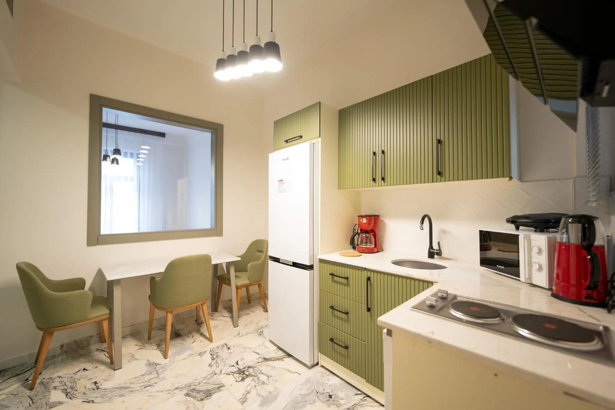 Kitchen or kitchenette in Monev Suites Hotel