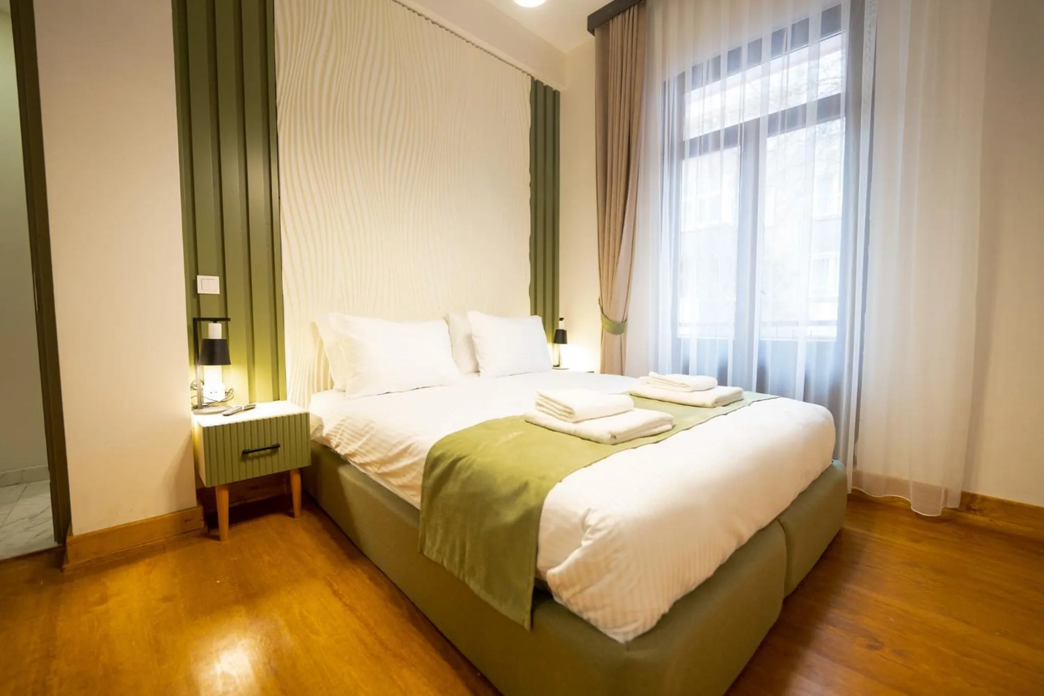 Bed in Monev Suites Hotel