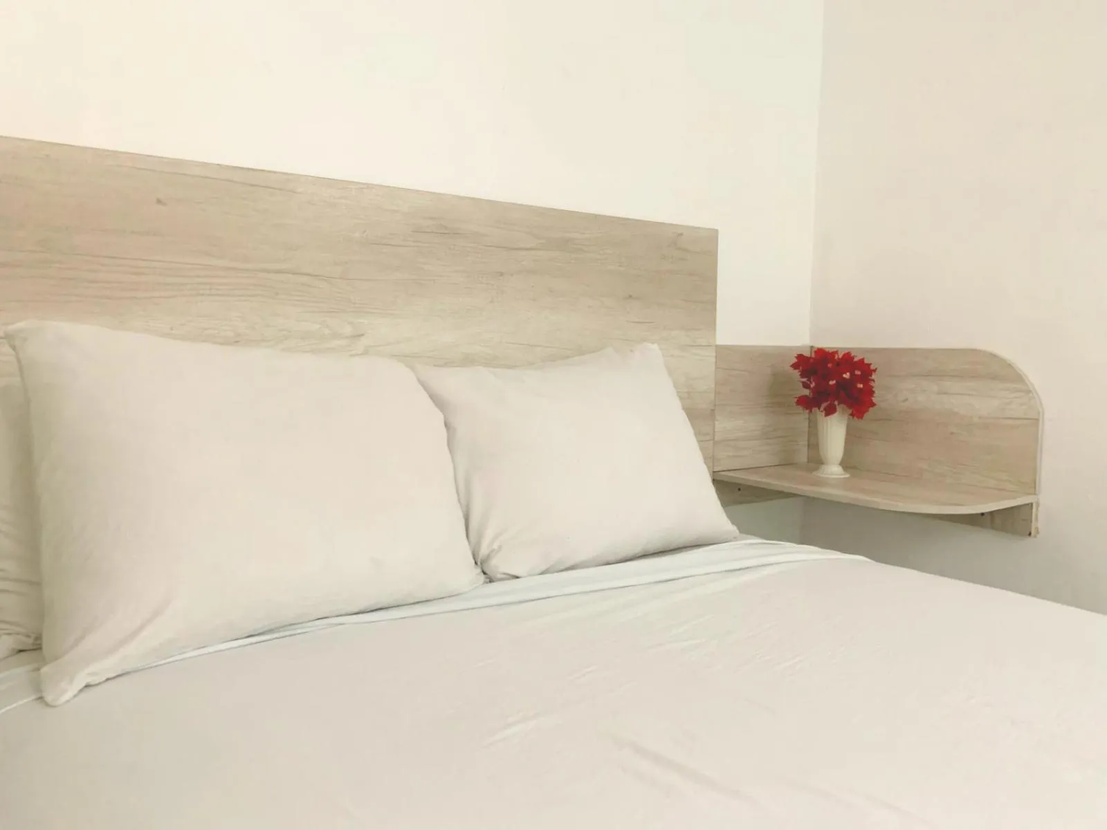 Bed in Pacific Coast Hotel