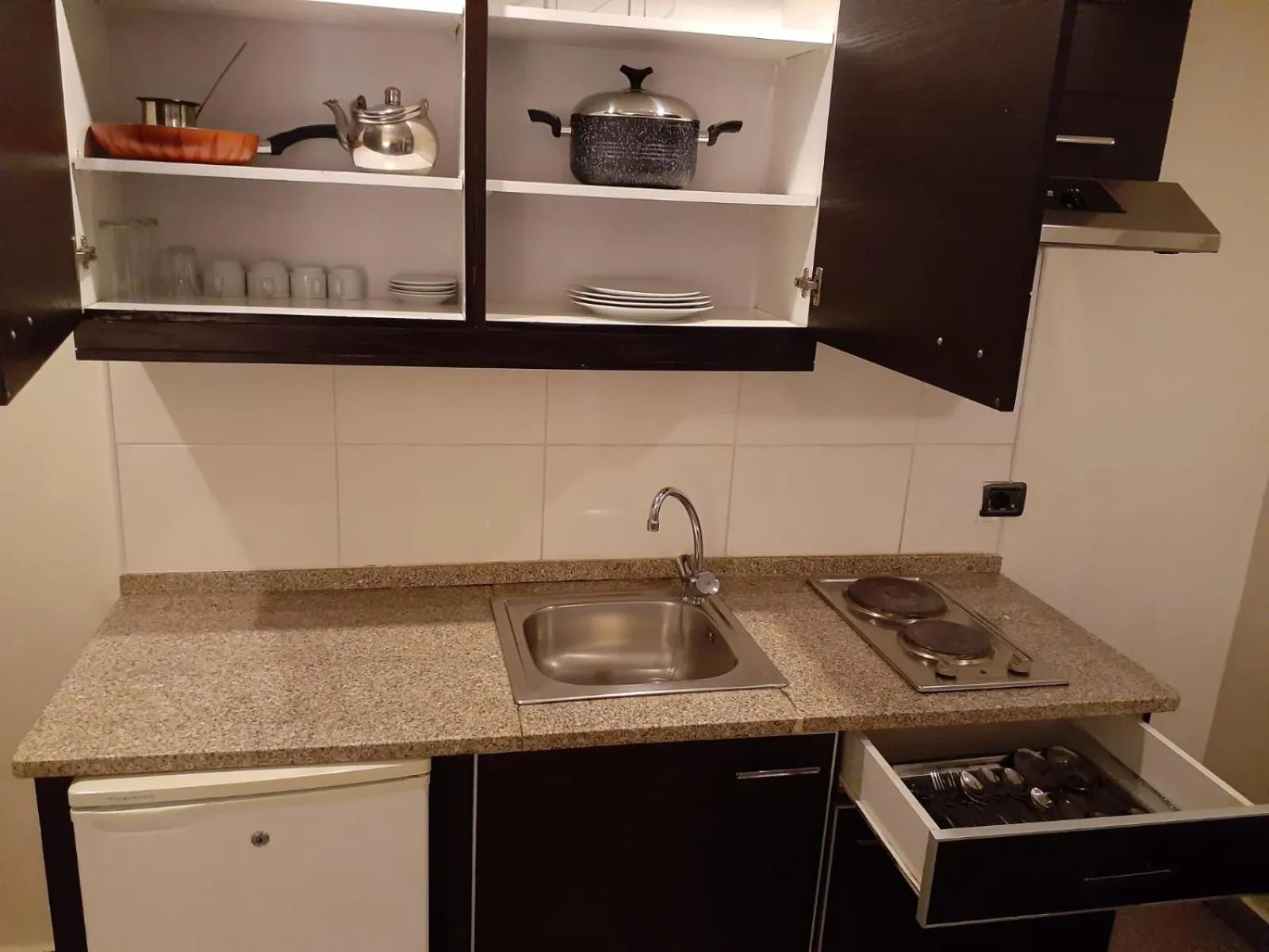 Kitchen or kitchenette in Tamrah Suites Hotel