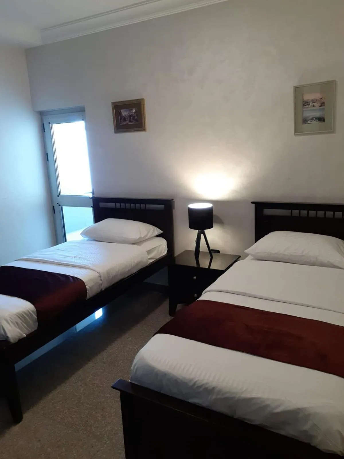 Bed in Tamrah Suites Hotel