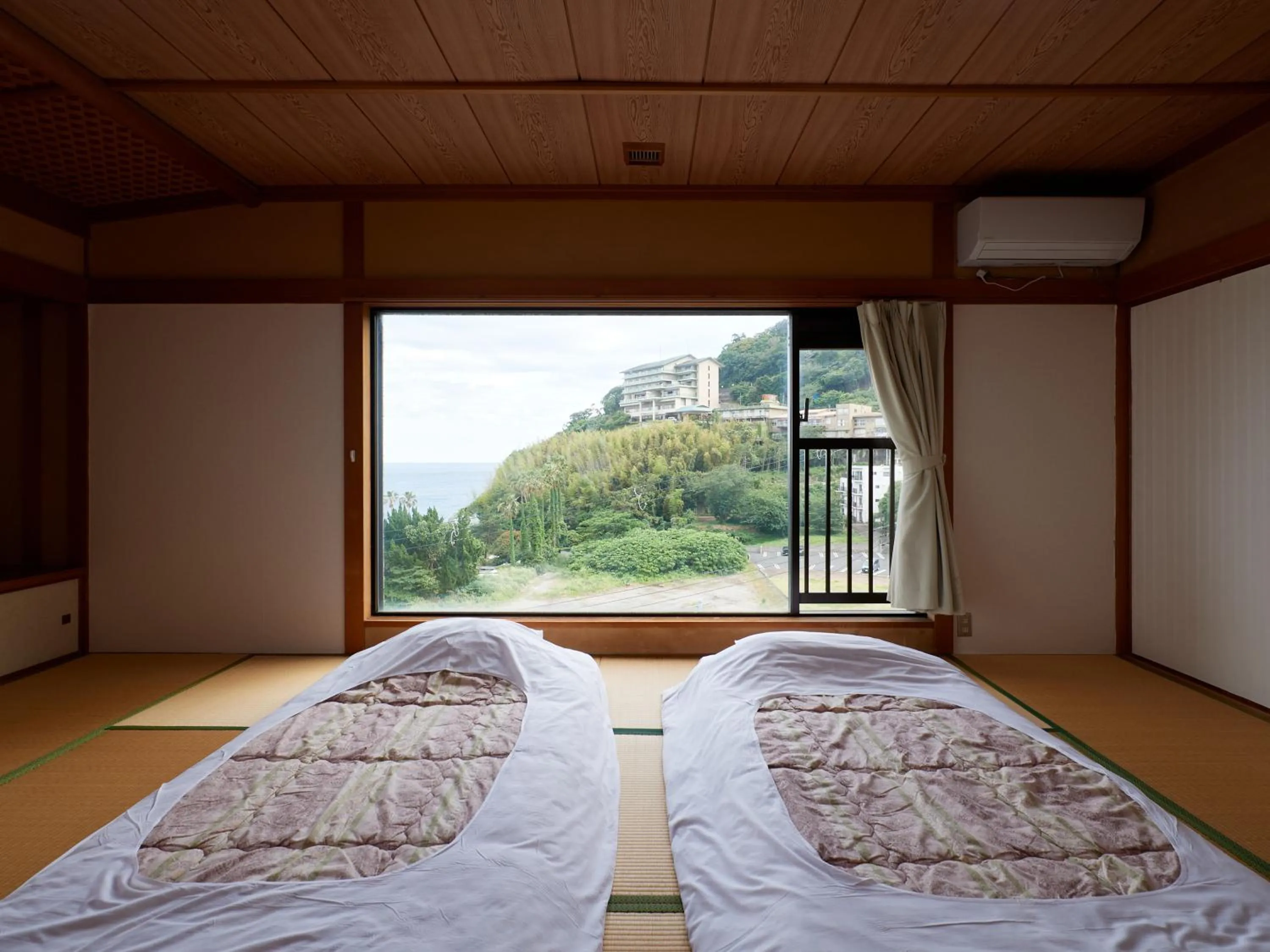 Bed in Izu Atagawa Onsen Hotel Gyokuryu