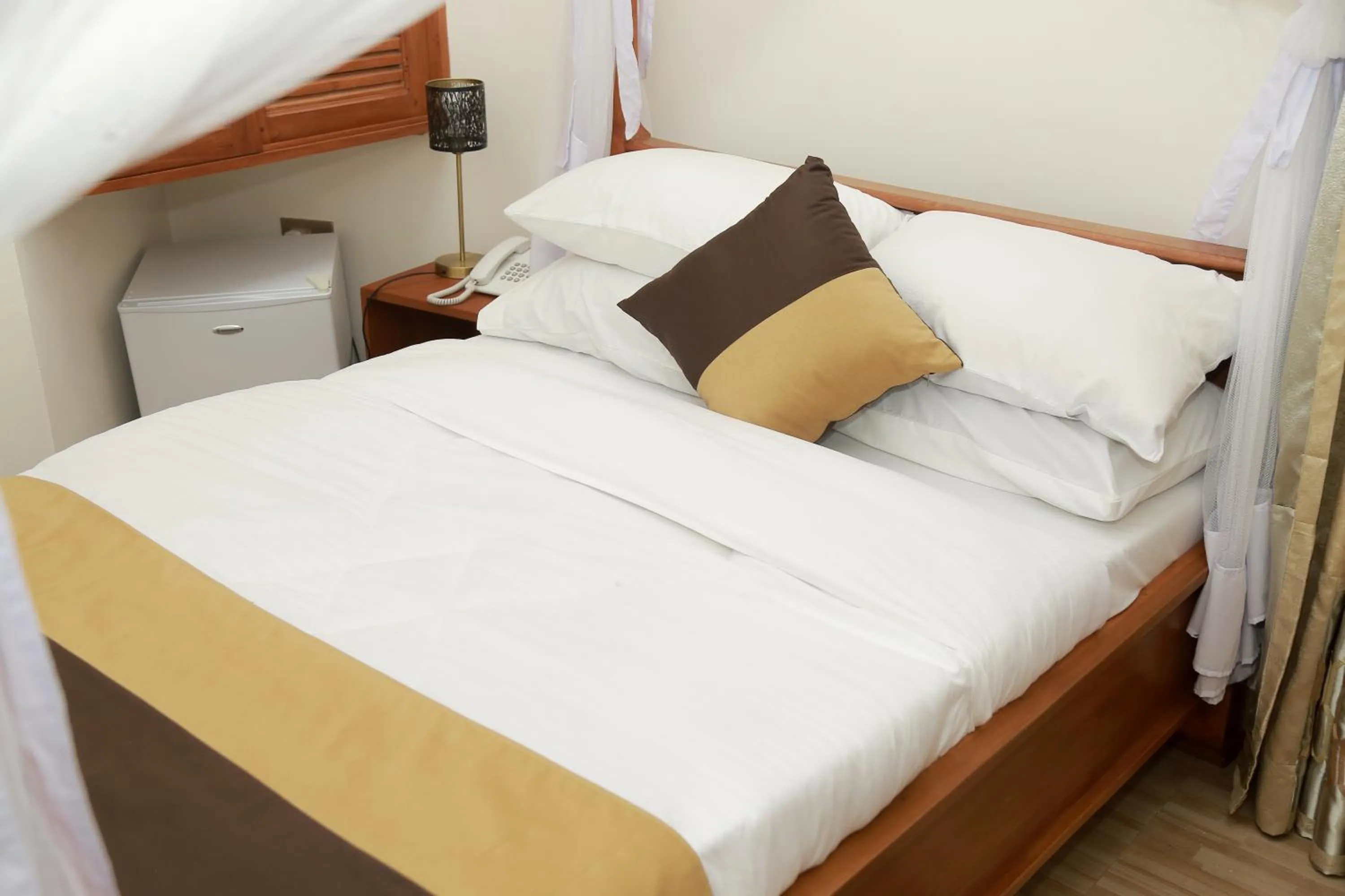 Bed in Wademac Arusha Inn Hotel