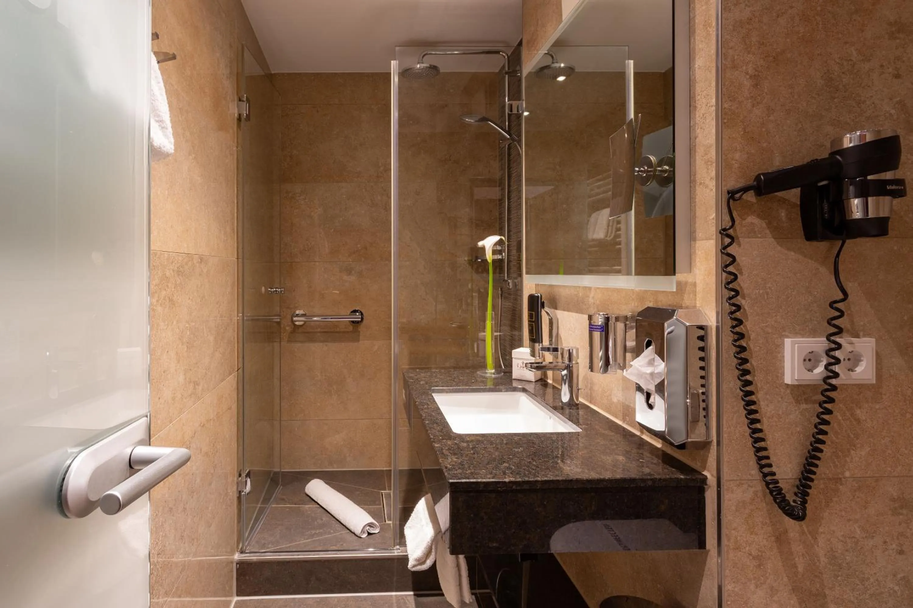 Bathroom in TIPTOP Hotel Burgschmiet Garni