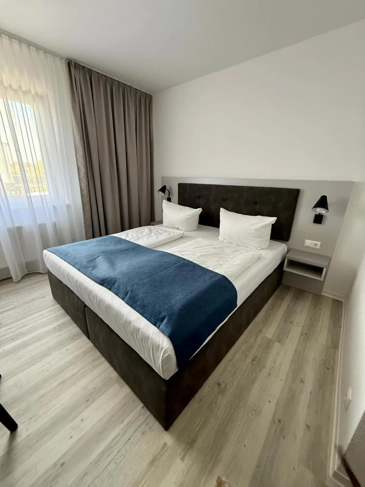 Bed in DORMERO Hotel Greifswald