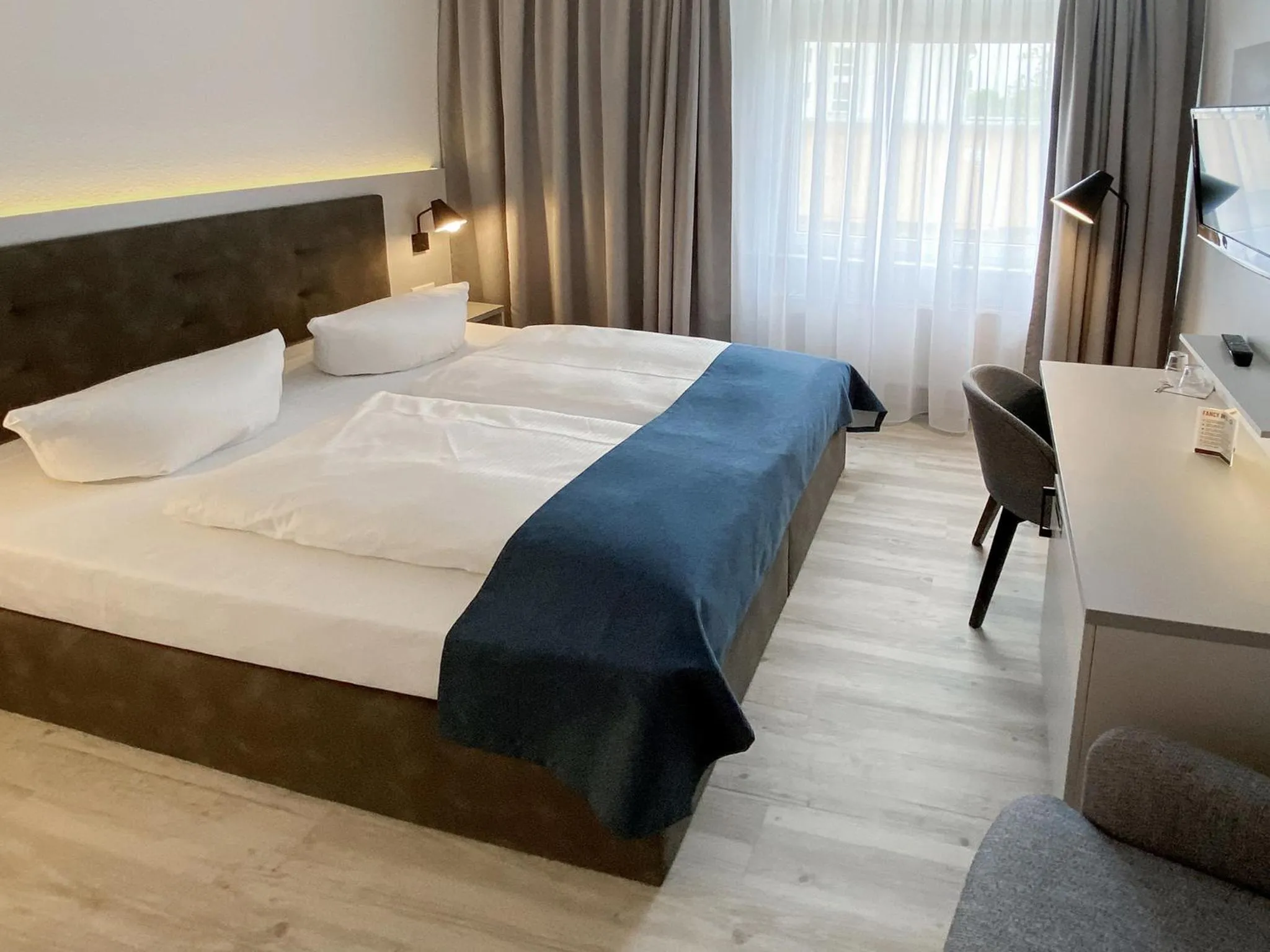 Bed in DORMERO Hotel Greifswald