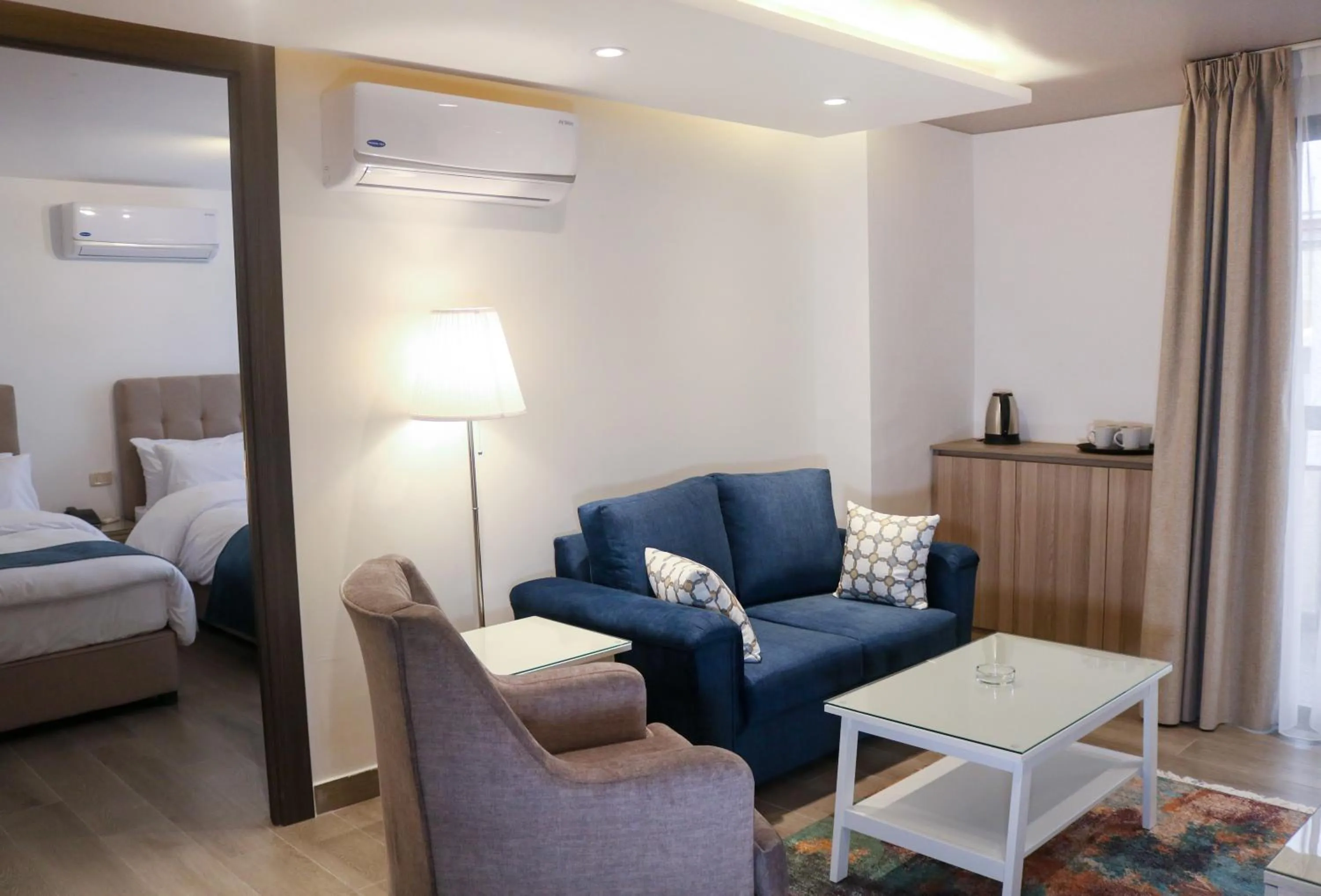 Seating area, Bed in Red Carpet Hotel & Suites