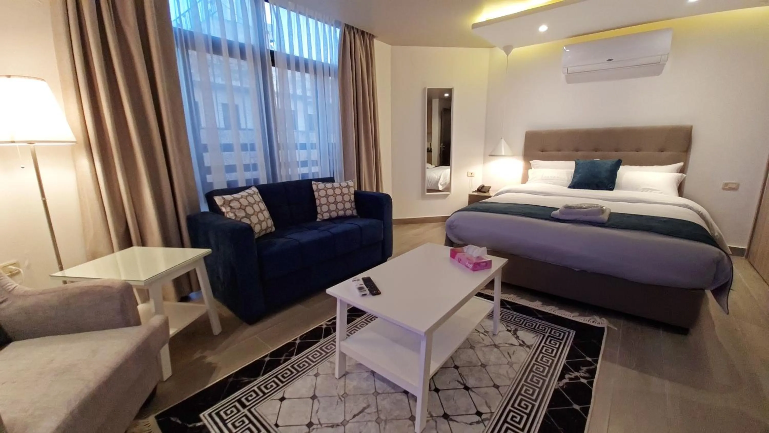 Bed in Red Carpet Hotel & Suites