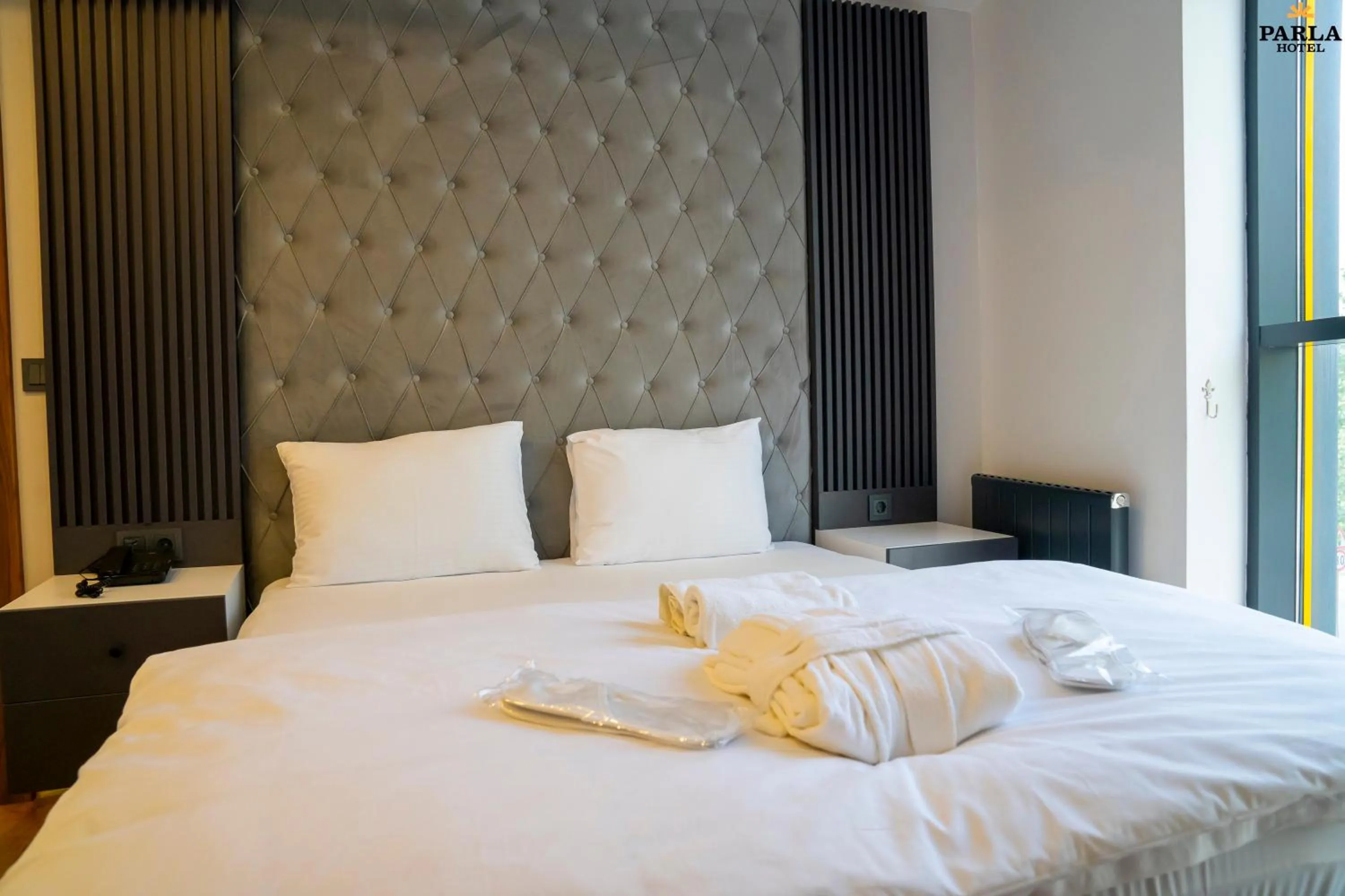 Bed in Parla Suite Hotel