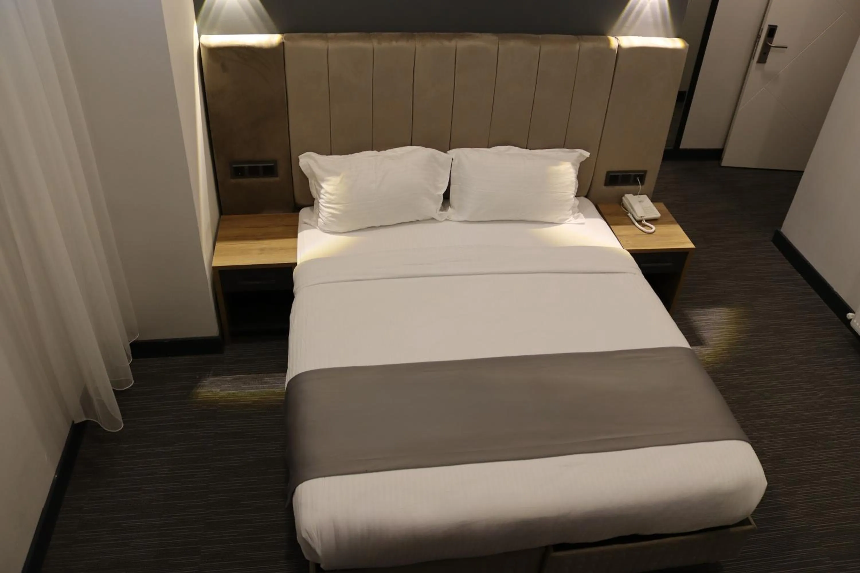 Bed in HOME PLUS Hotel