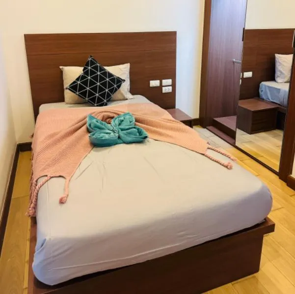 Bed in The Astra Condo Changkhlan in Chiang Mai