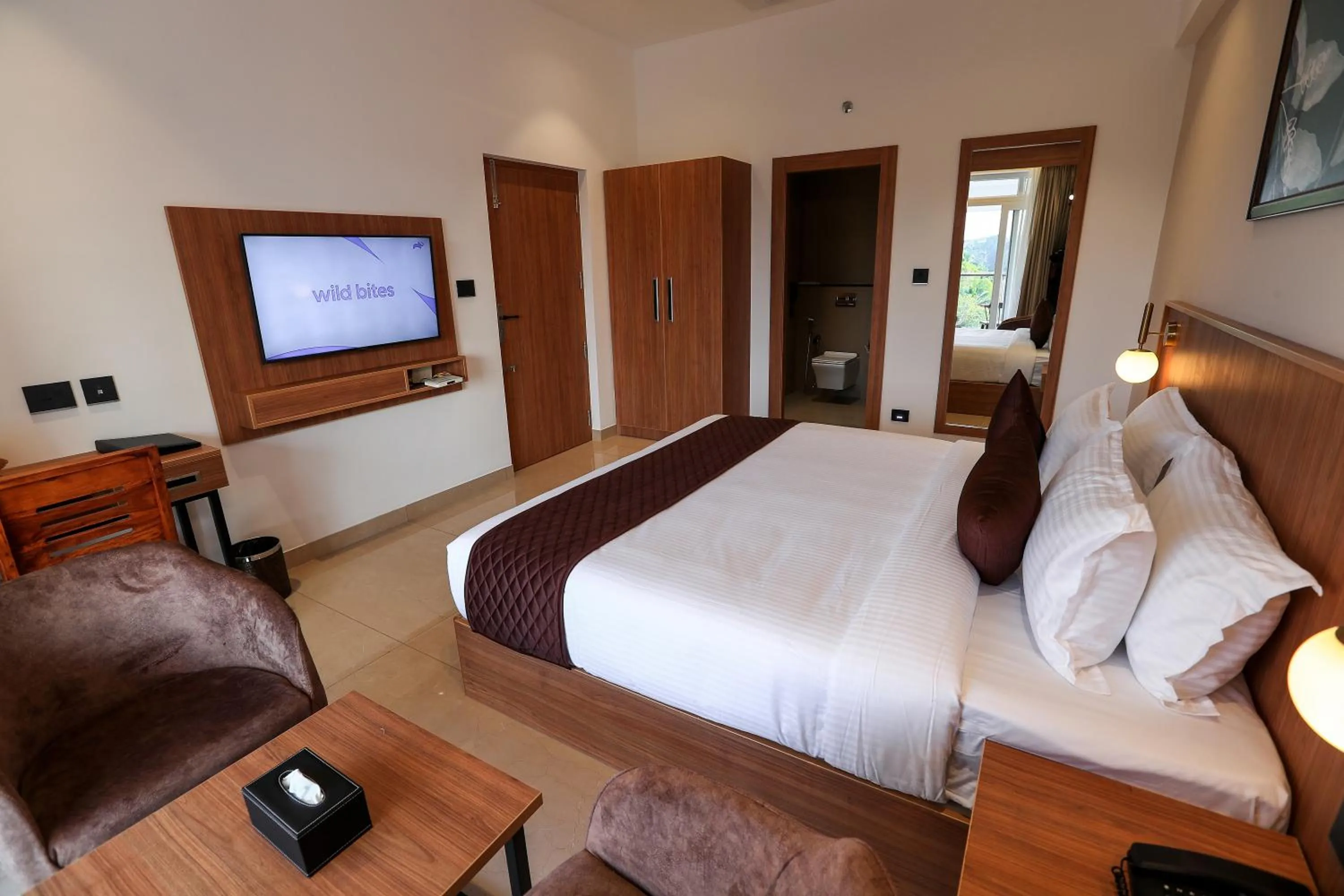 Bed in Hotel Saffron Wayanad