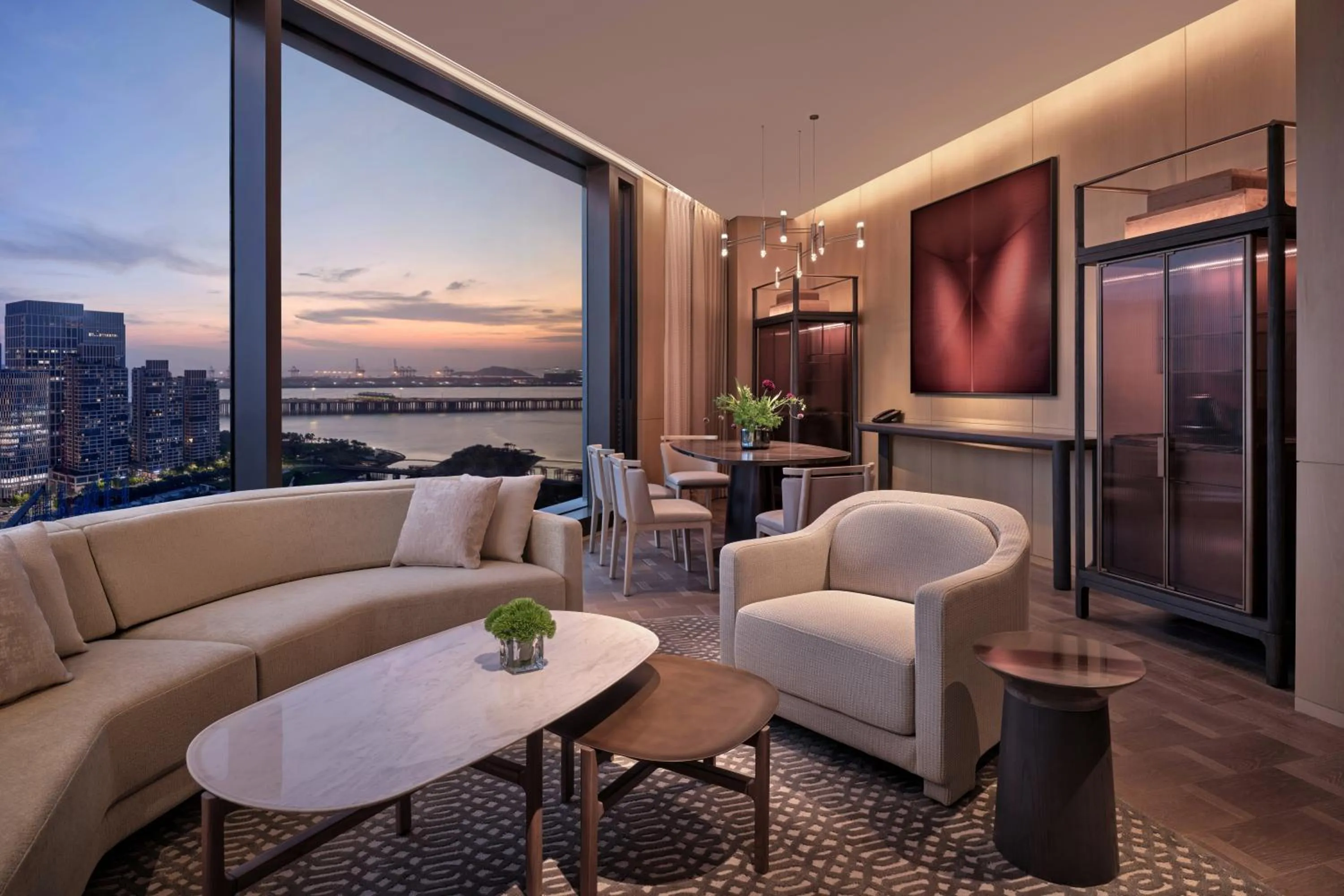 Living room in Conrad Shenzhen, the first art museum hotel in Greater Bay Area with the stunning bay and sunset view in the hotel terrace