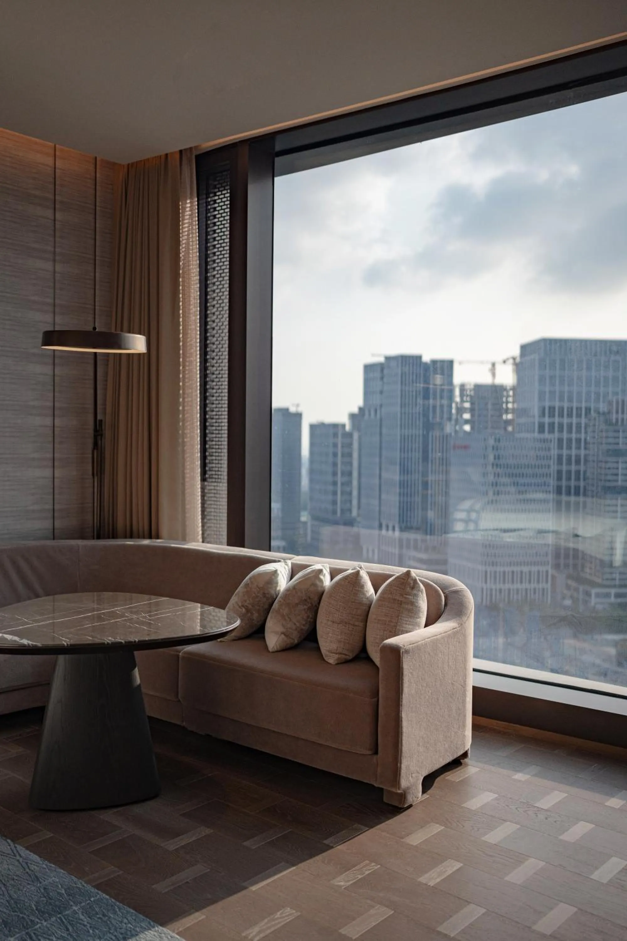 Seating area in Conrad Shenzhen, the first art museum hotel in Greater Bay Area with the stunning bay and sunset view in the hotel terrace