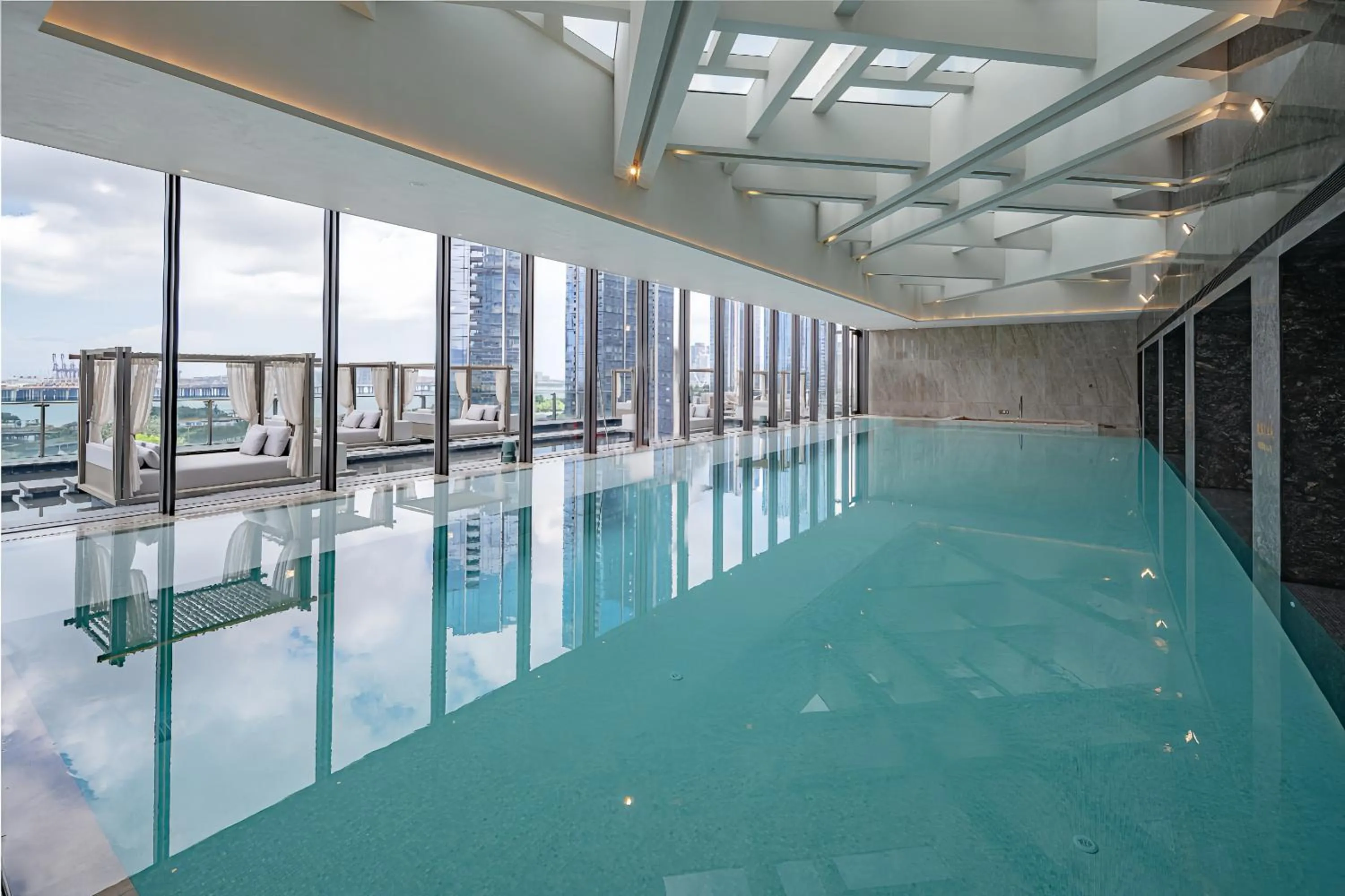 Swimming pool in Conrad Shenzhen, the first art museum hotel in Greater Bay Area with the stunning bay and sunset view in the hotel terrace