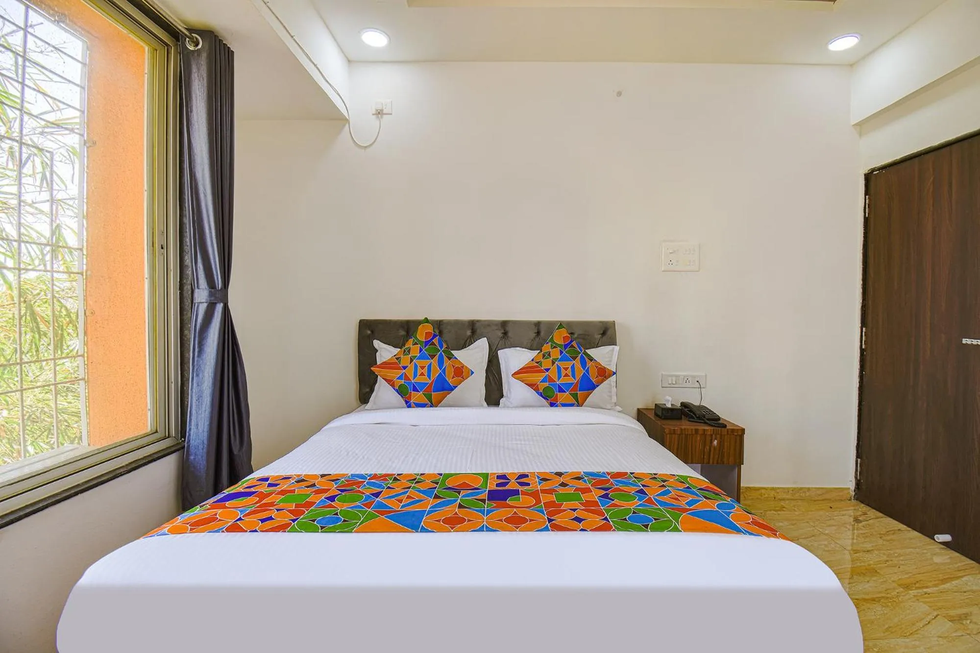 Bed in FabHotel Red Velvet Inn & Suites