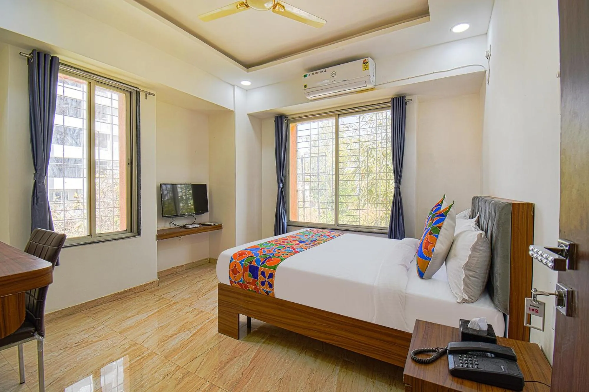 Bed in FabHotel Red Velvet Inn & Suites