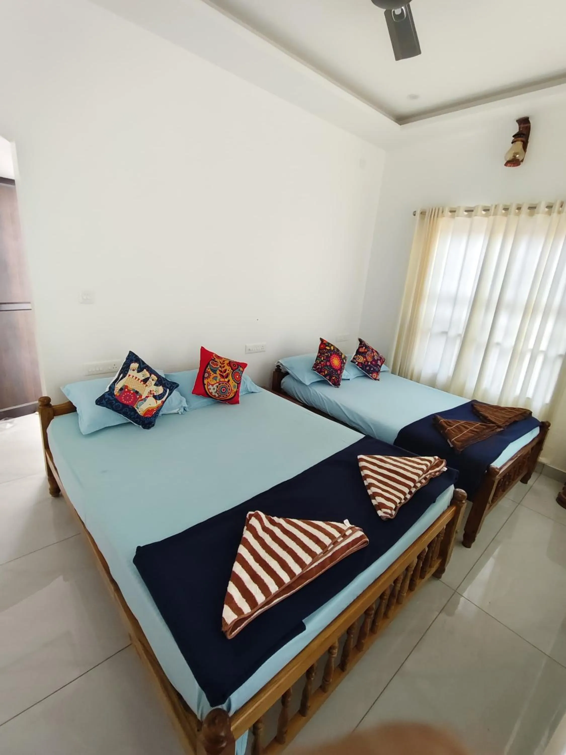 Bed in NALINAM HOMESTAY
