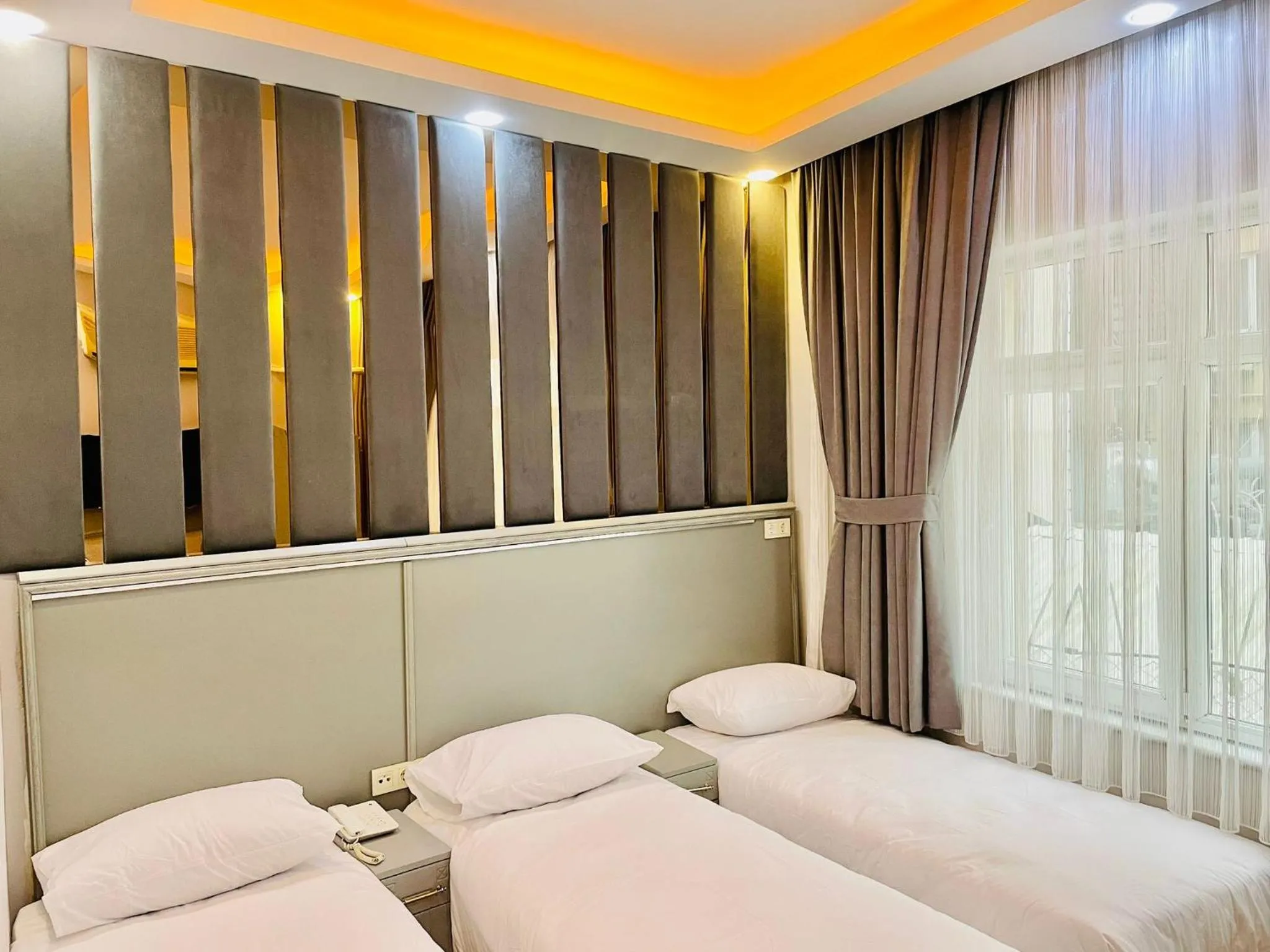 Bed in Crowned Plus Hotel