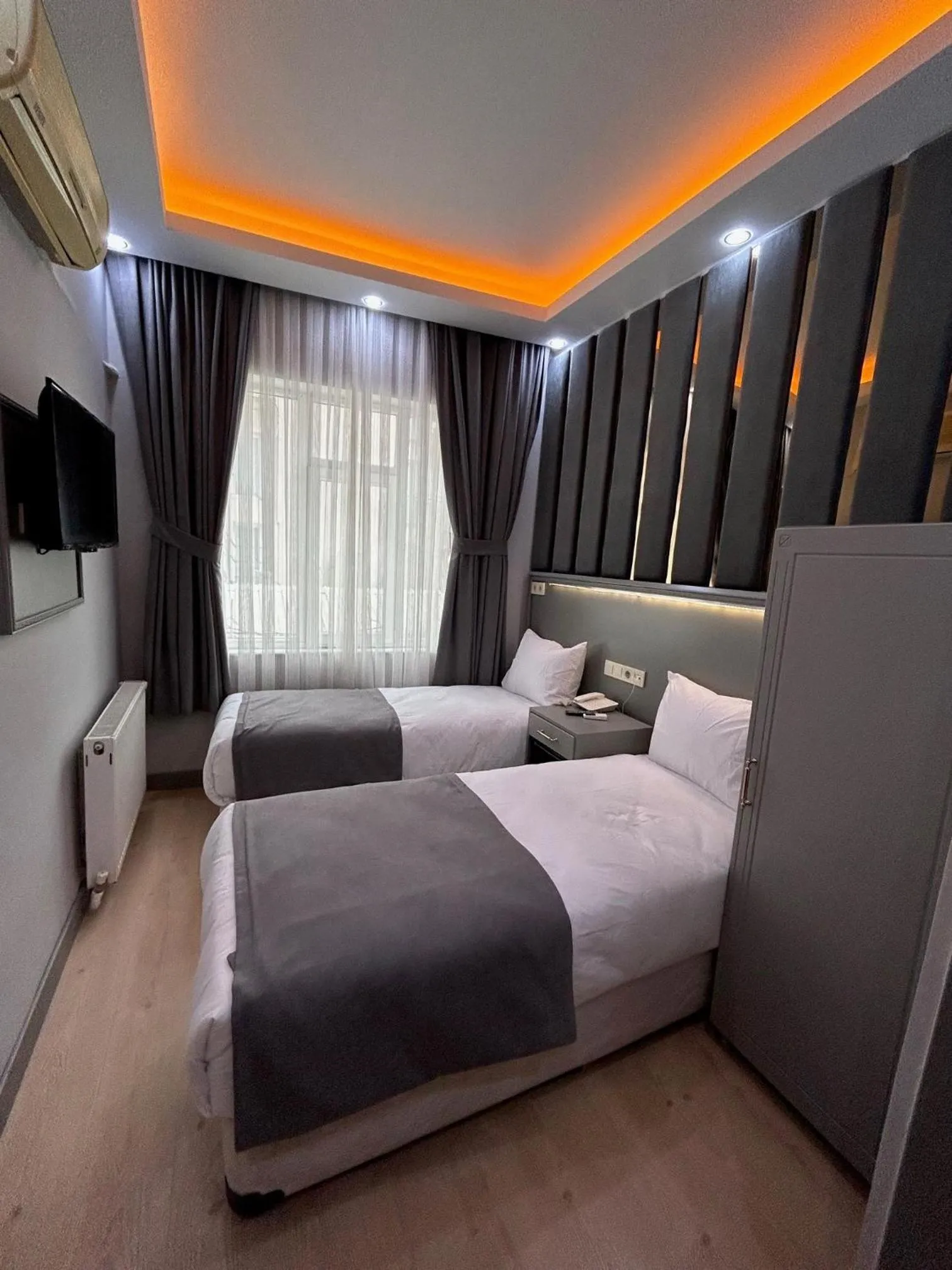 Communal lounge/ TV room, Bed in Crowned Plus Hotel