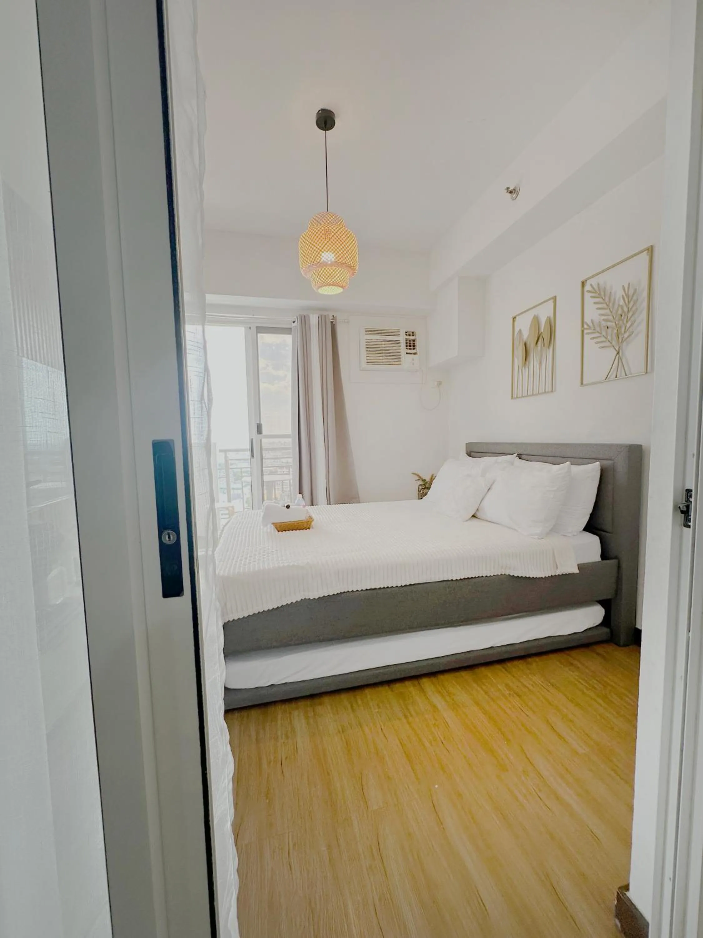 Bed in Zinnia Towers 1BR Condo with PS4 Karaoke Netflix & Swimming Pool