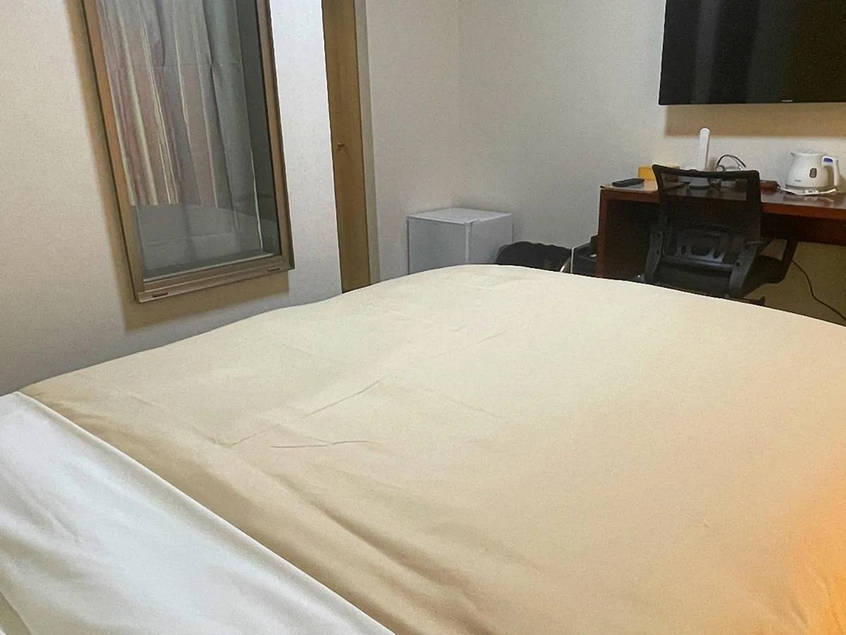 Bed in Jisco Hotel Obama Onsen