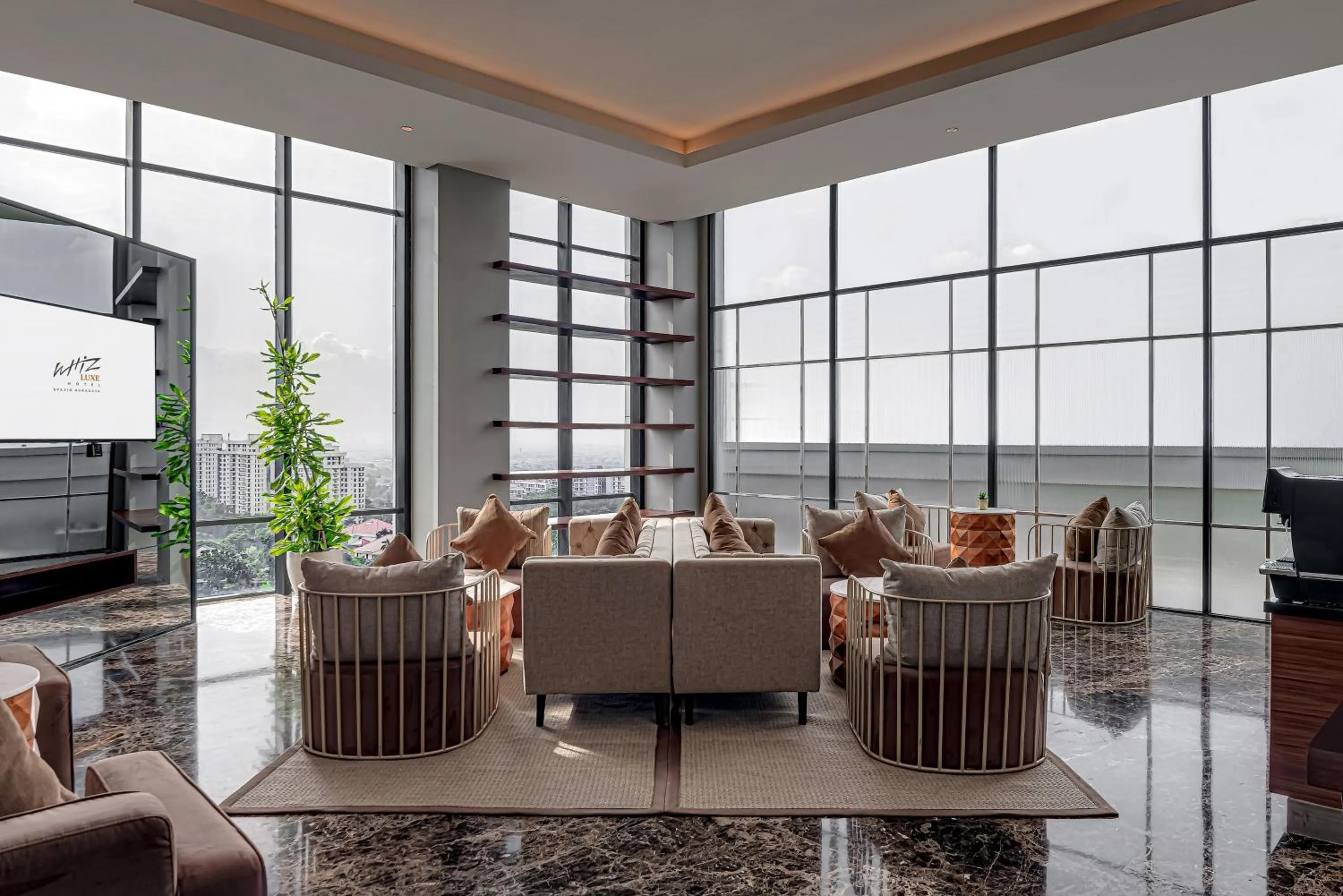 Communal lounge/ TV room in Whiz Luxe Hotel Spazio Surabaya