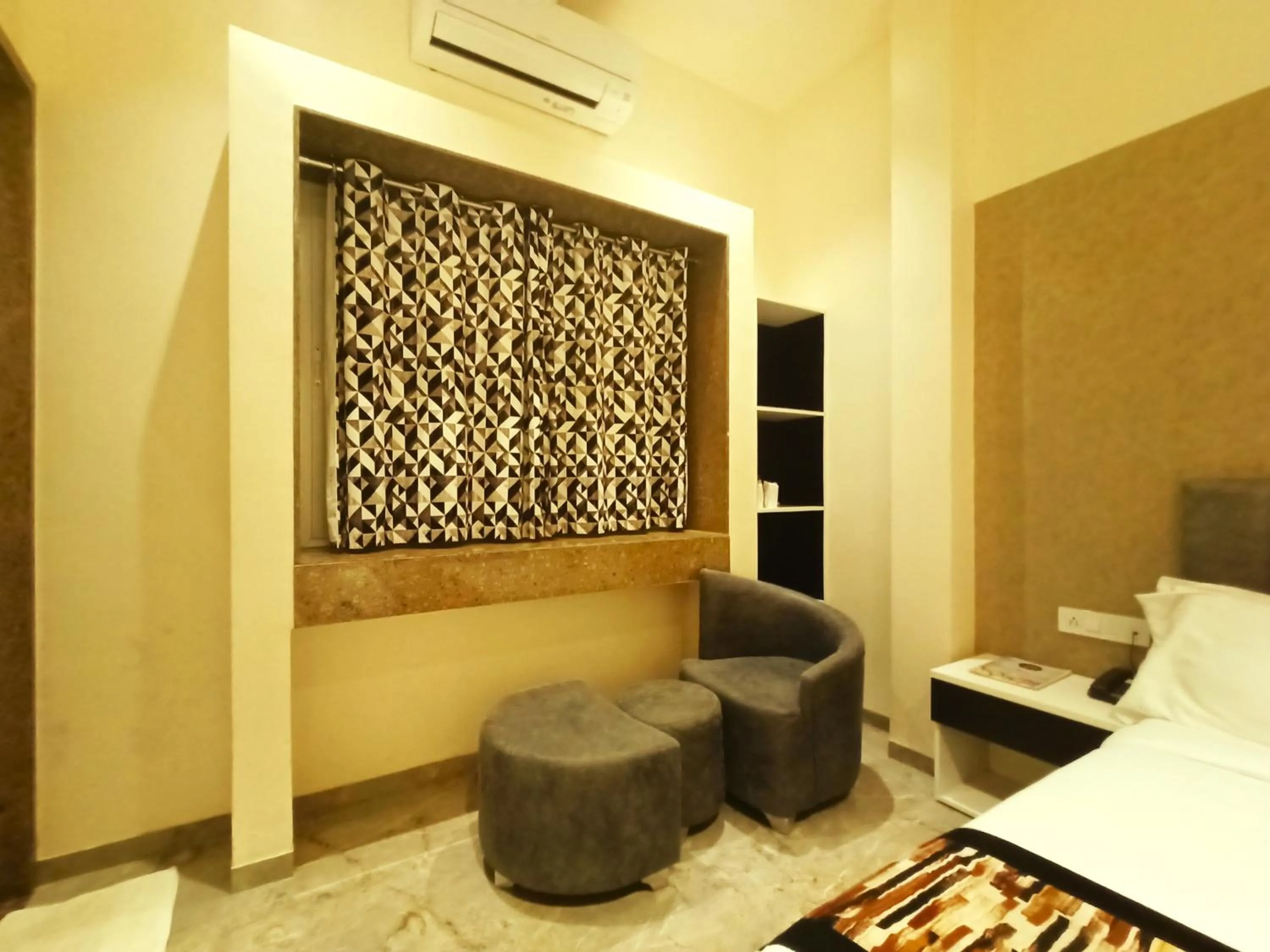 Seating area, Bed in Radhamangal Colors Inn